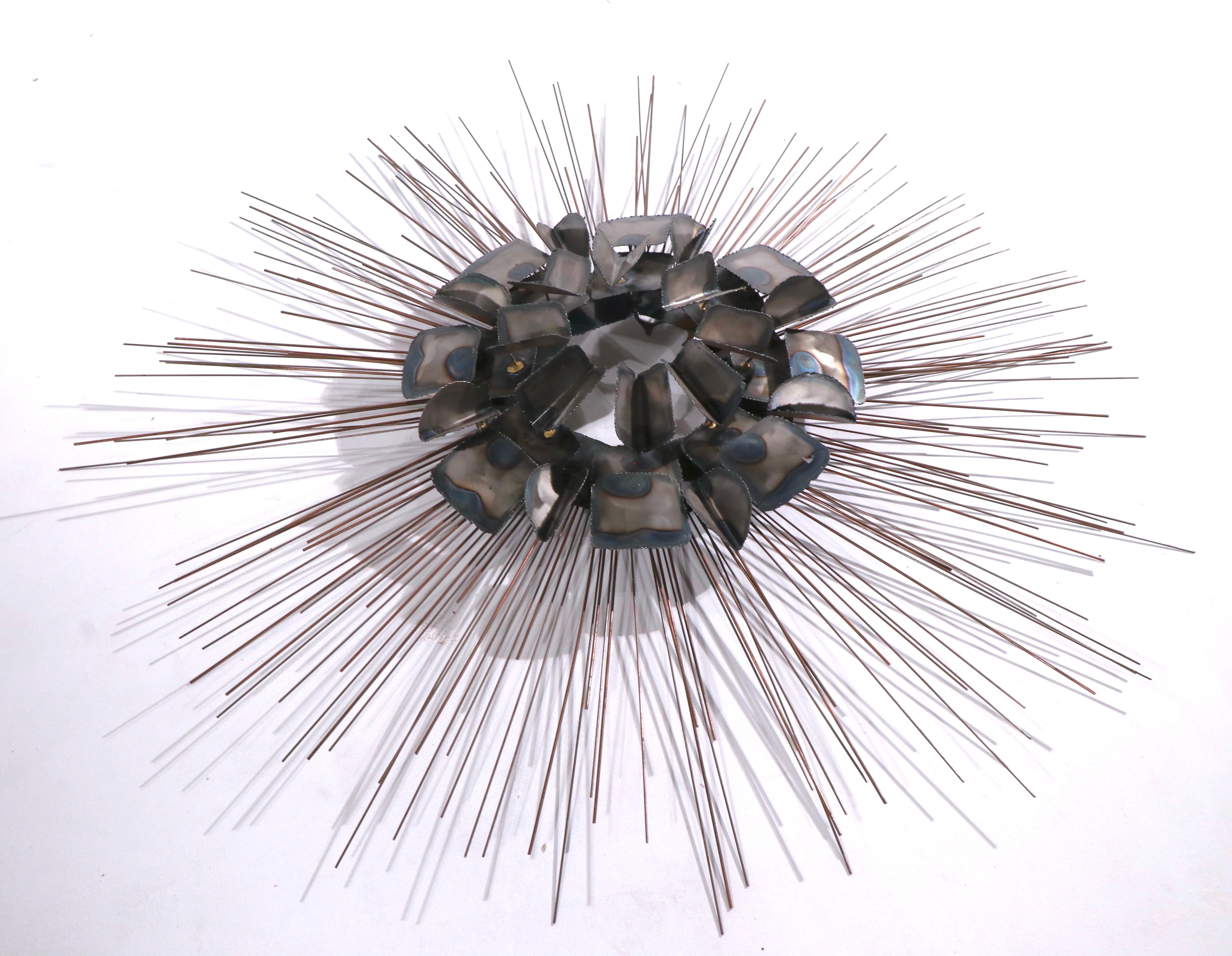 Spectacular Brutalist starburst wall hanging sculpture attributed to Curtis Jere, unsigned. This example is unusual in that it has a dimensional torch cut center, with wire rays radiating from the center. original, clean and ready to hang condition.