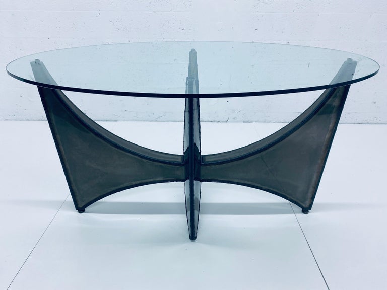 Oval glass top center or dining table with welded steel base in the style of Paul Evans and Silas Seandel. Manufacturer unknown, circa 1970s. Use with the existing glass or have a new piece made specific to your design. Could also be used a console