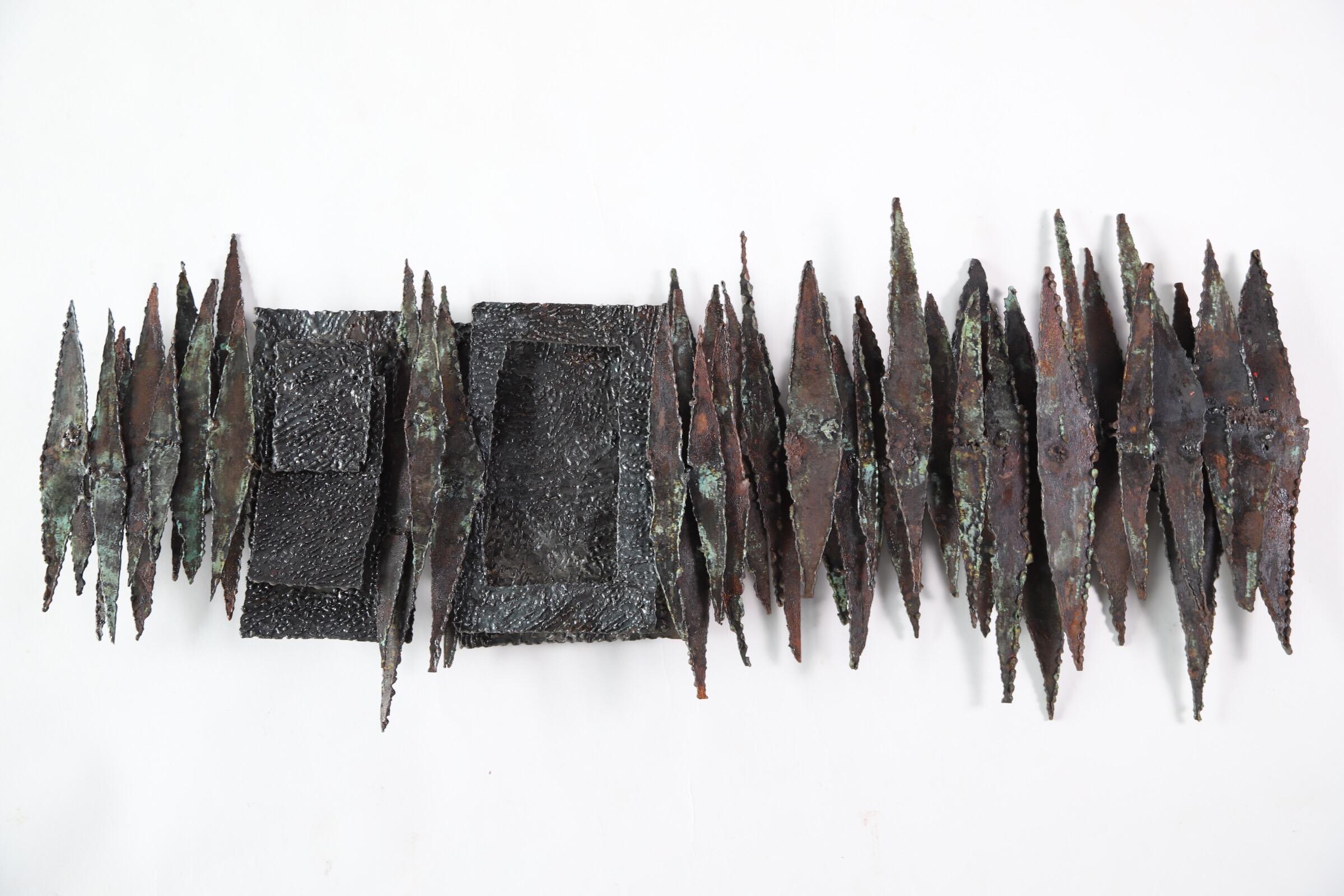 Extraordinary vintage Brutalist steel wall sculpture. Consisting of soldered and welded torch cut steel. Layered to create depth and expand the endless texture. Very much in the style of Paul Evans and Silas Seandel. Can be hung vertically or