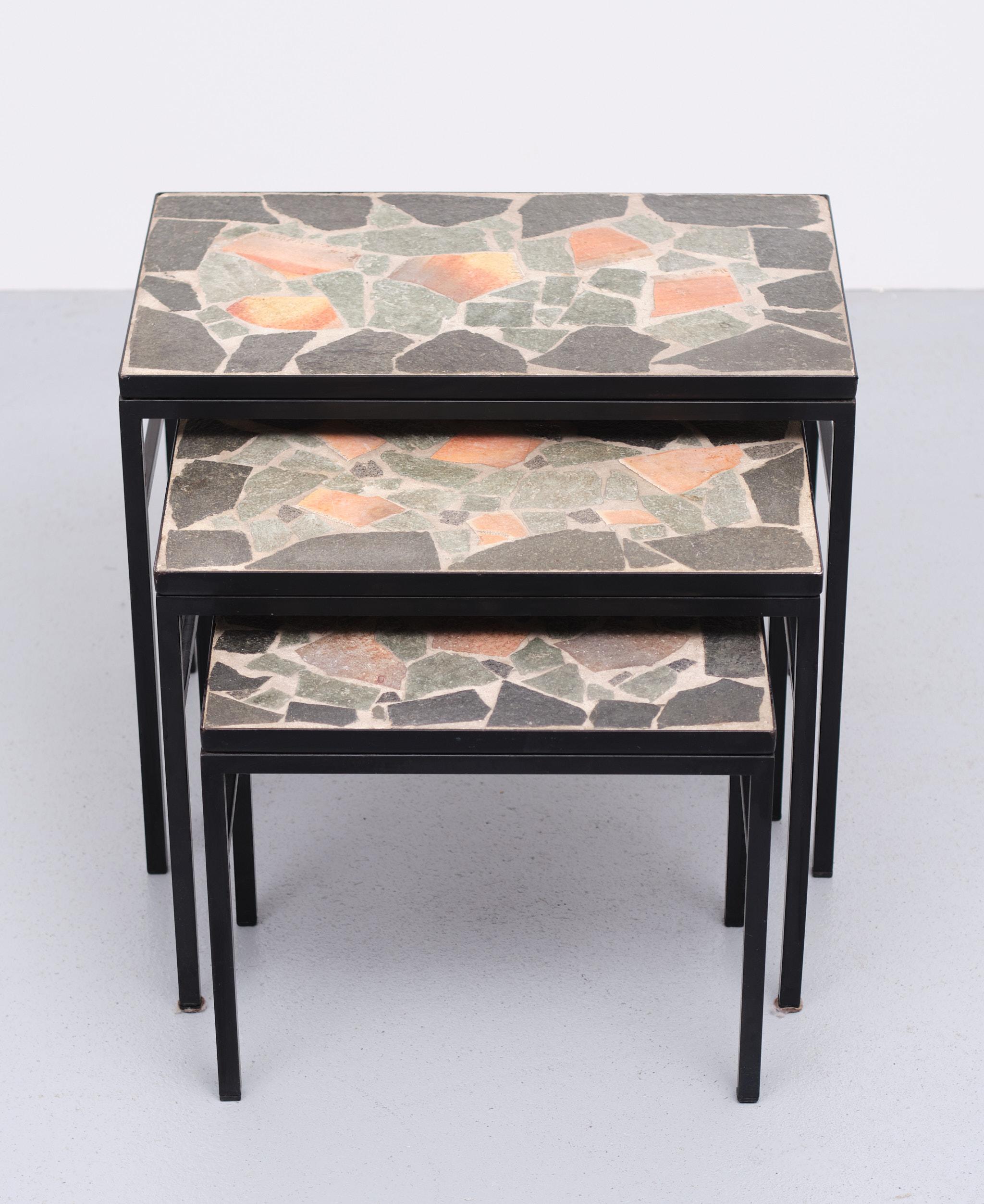 Very nice set of Three brutalist Nesting table. Stone inlay, in grey and red colors,
Black metal frame. Very good condition. 
 Measures: height 43 cm width 52 cm depth 31 cm
height 37 cm width 45 cm depth 27 cm
height 31 cm width 38 cm depth 23