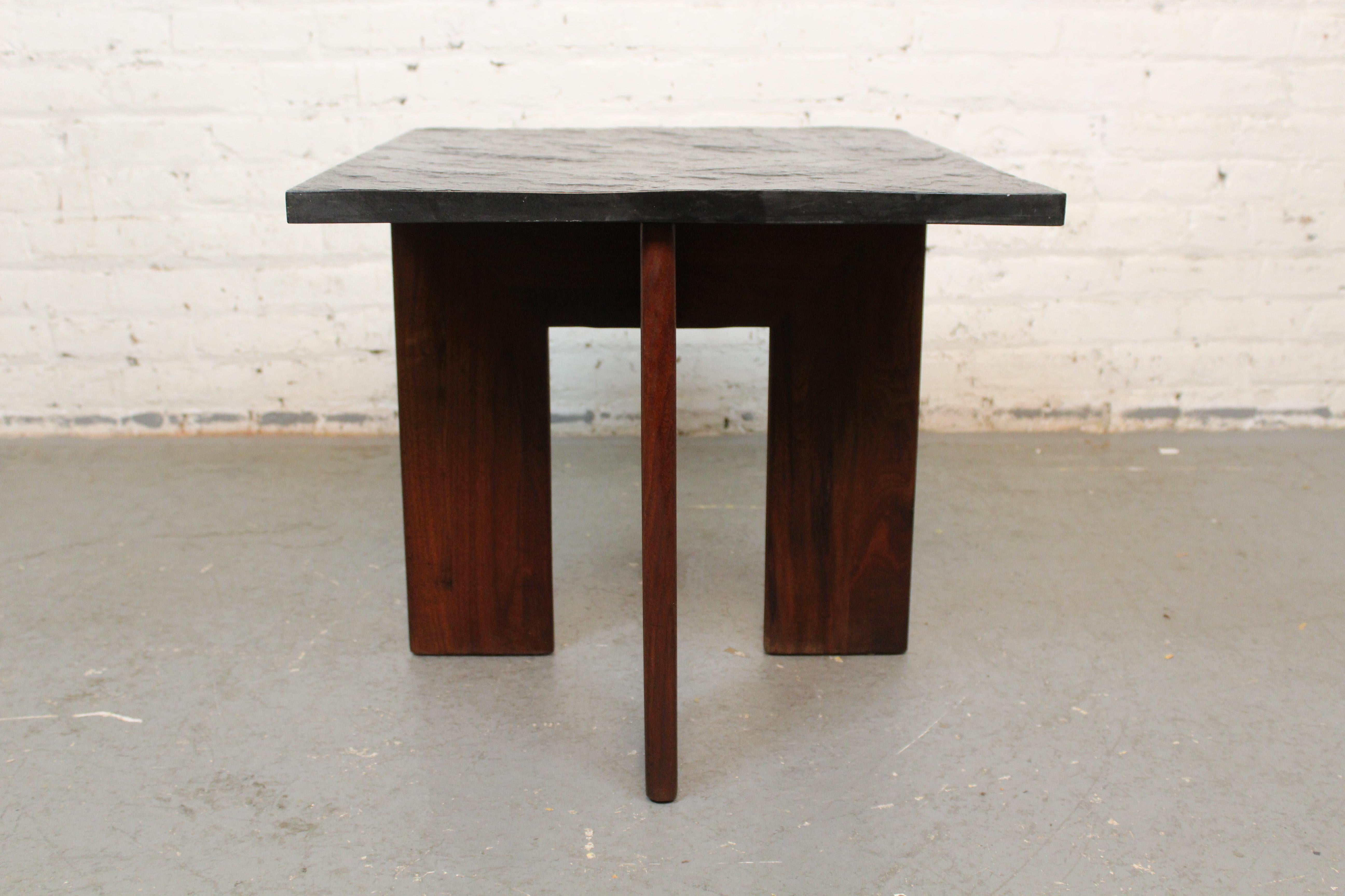 Add a touch of brutality to any space with this charming side table by Adrian Pearsall for his Craft Associates brand of Wilkes Barre, Pennsylvania. Featuring a stark solid rosewood cross base boasting screw-less joinery and robust slate free