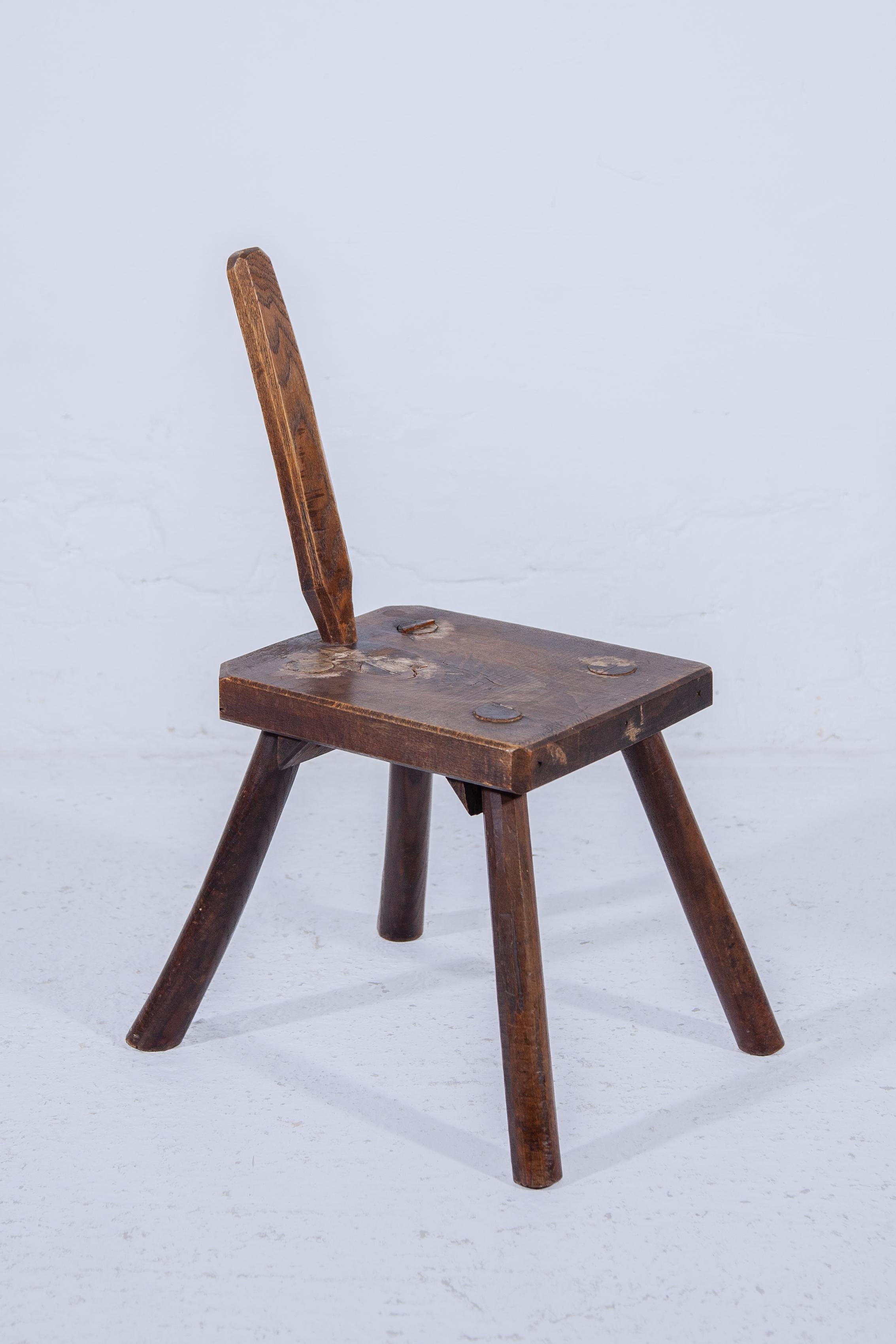 Authentic antique solid wooden stool used in the countryside. Cows have been milked for centuries and traditionally this was done manually. Traditionally, the milkman went to milk the cow in a stable or in the meadow using a milk stool. Thanks to
