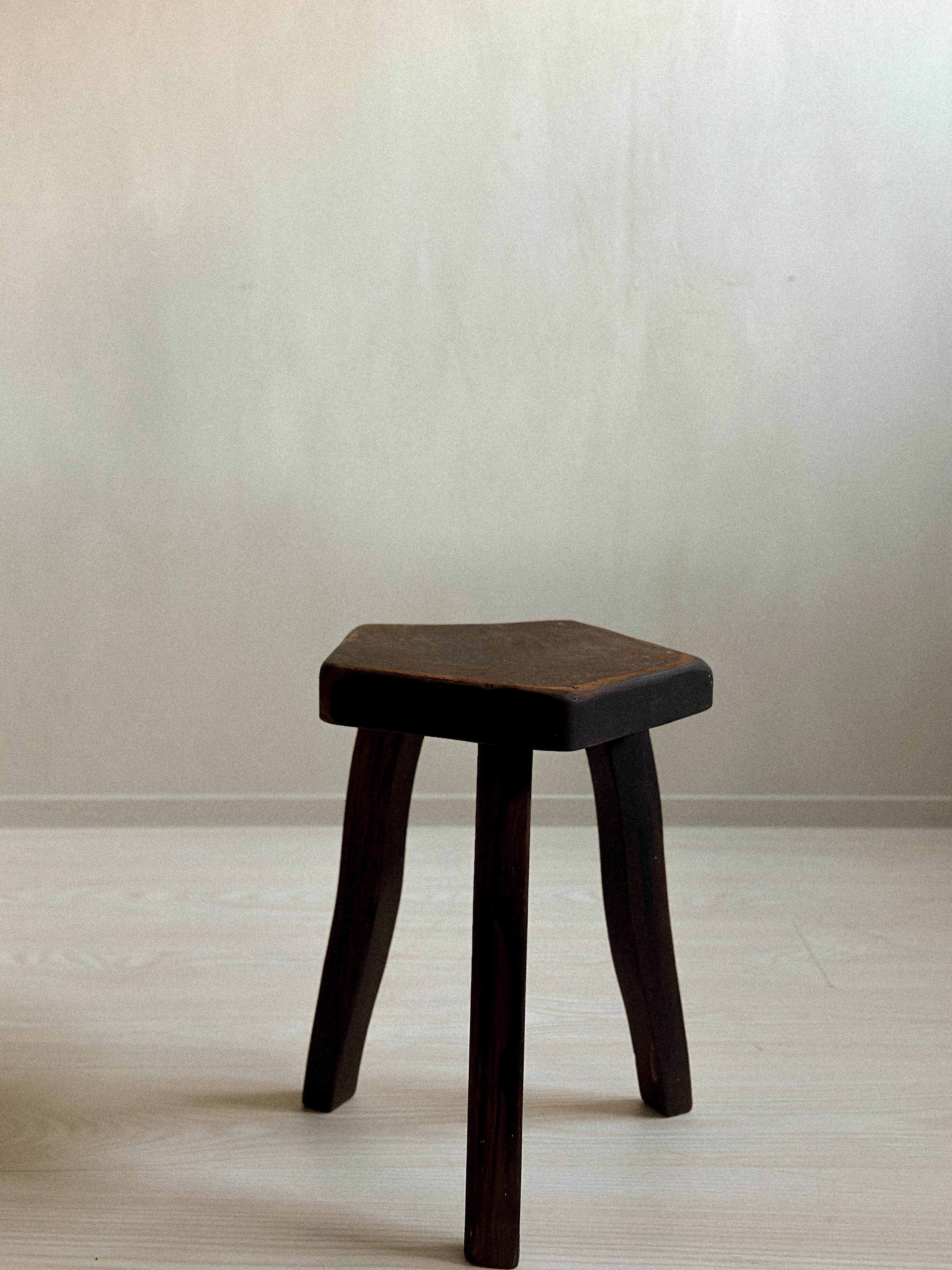 A brutalist stool manufactured by Aranjou, France, c. 1960s. Massive dark stained oak and organic shape. 

Wear consistent with age

