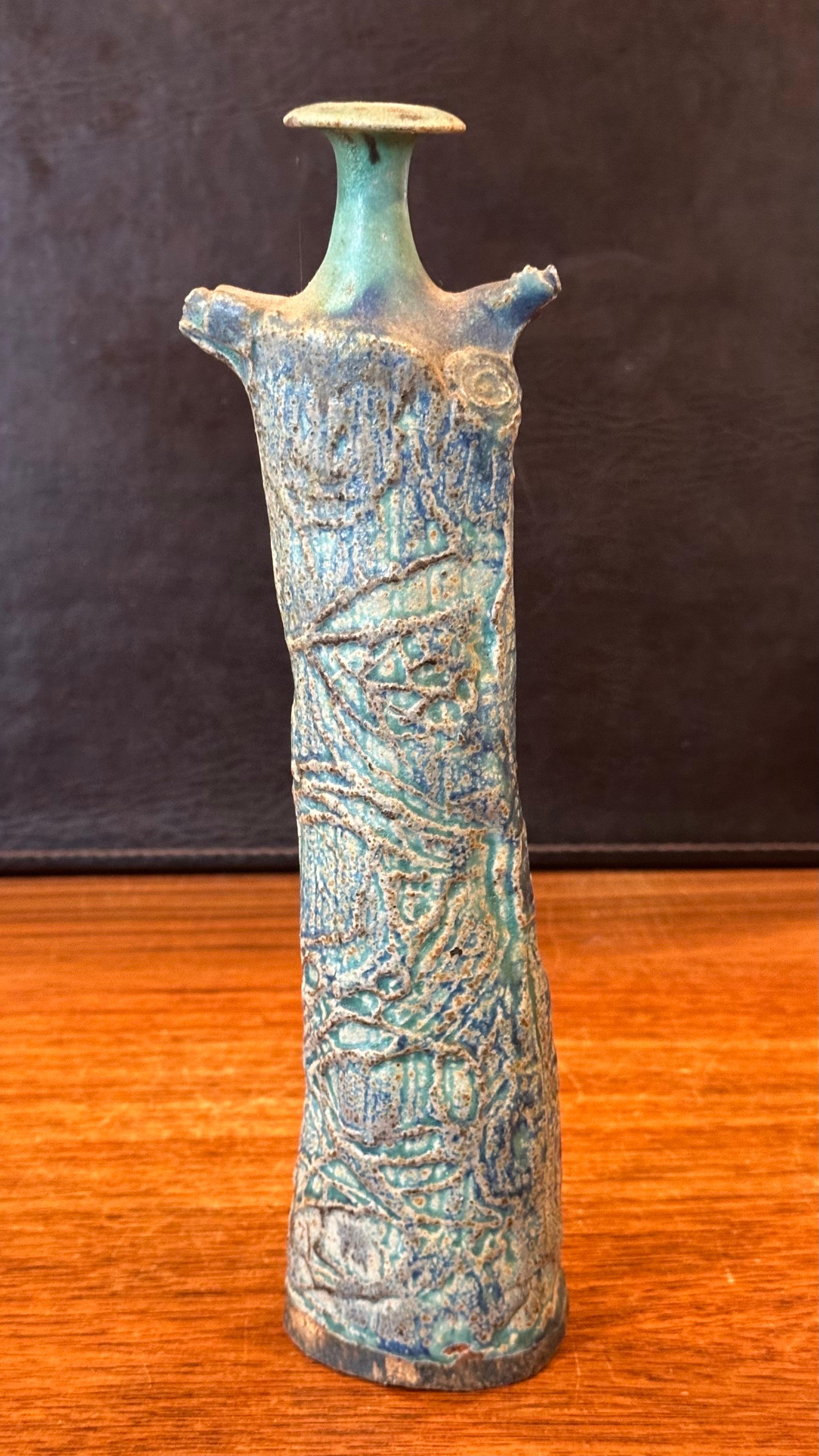 An interesting figural brutalist studio pottery stoneware vase, circa 1960s. It is has an abstract Picasso influenced look to it.  Very cool and different piece that is signed on the underside. The vase is in very good condition with no chips or