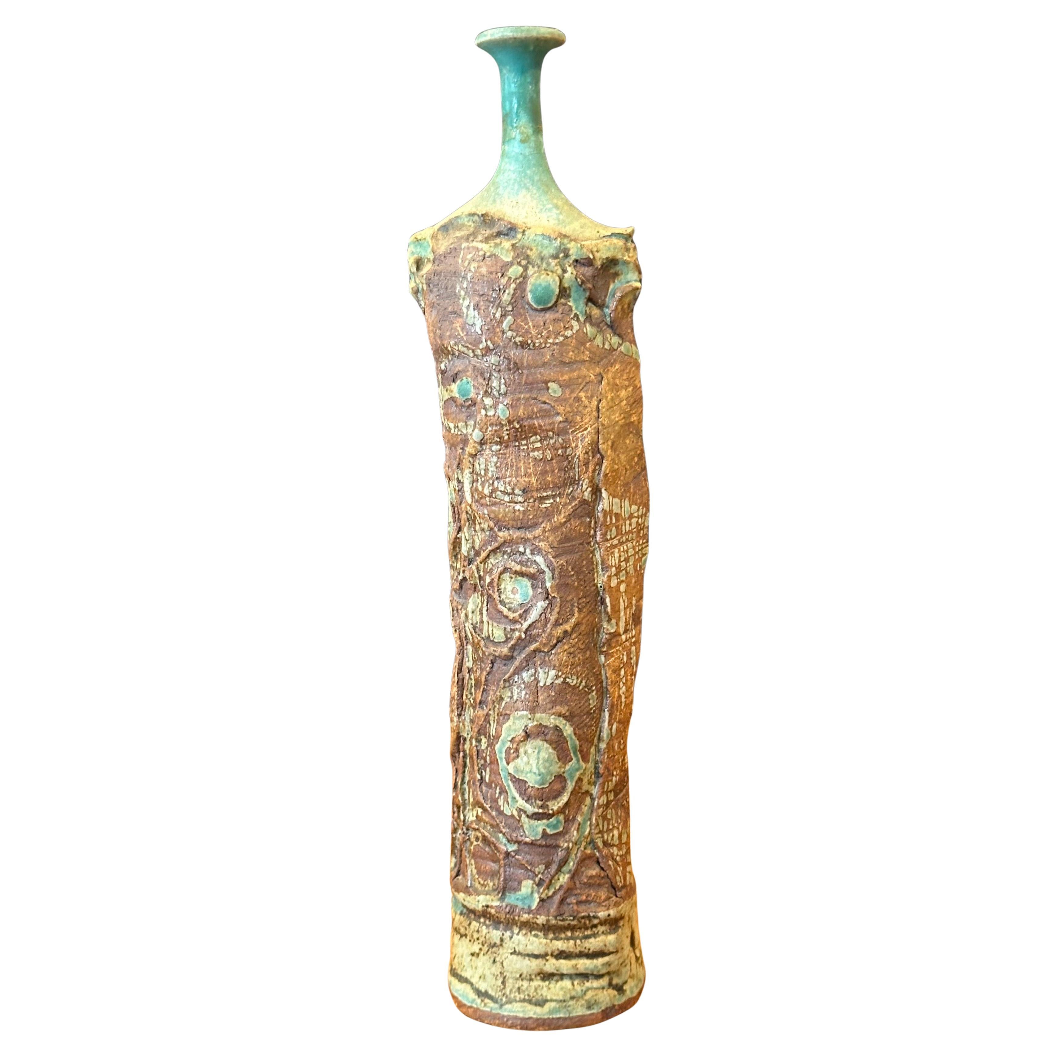 An interesting figural brutalist studio pottery stoneware vase, circa 1960s. It is has an abstract Picasso influenced look to it.  Very cool and different piece that is signed on the underside. The vase is in very good condition with no chips or