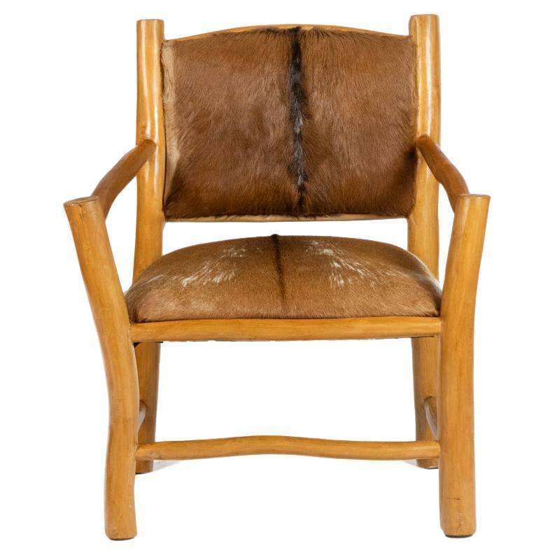 Brutalist style armchair in elm and goatskin, 1970s For Sale