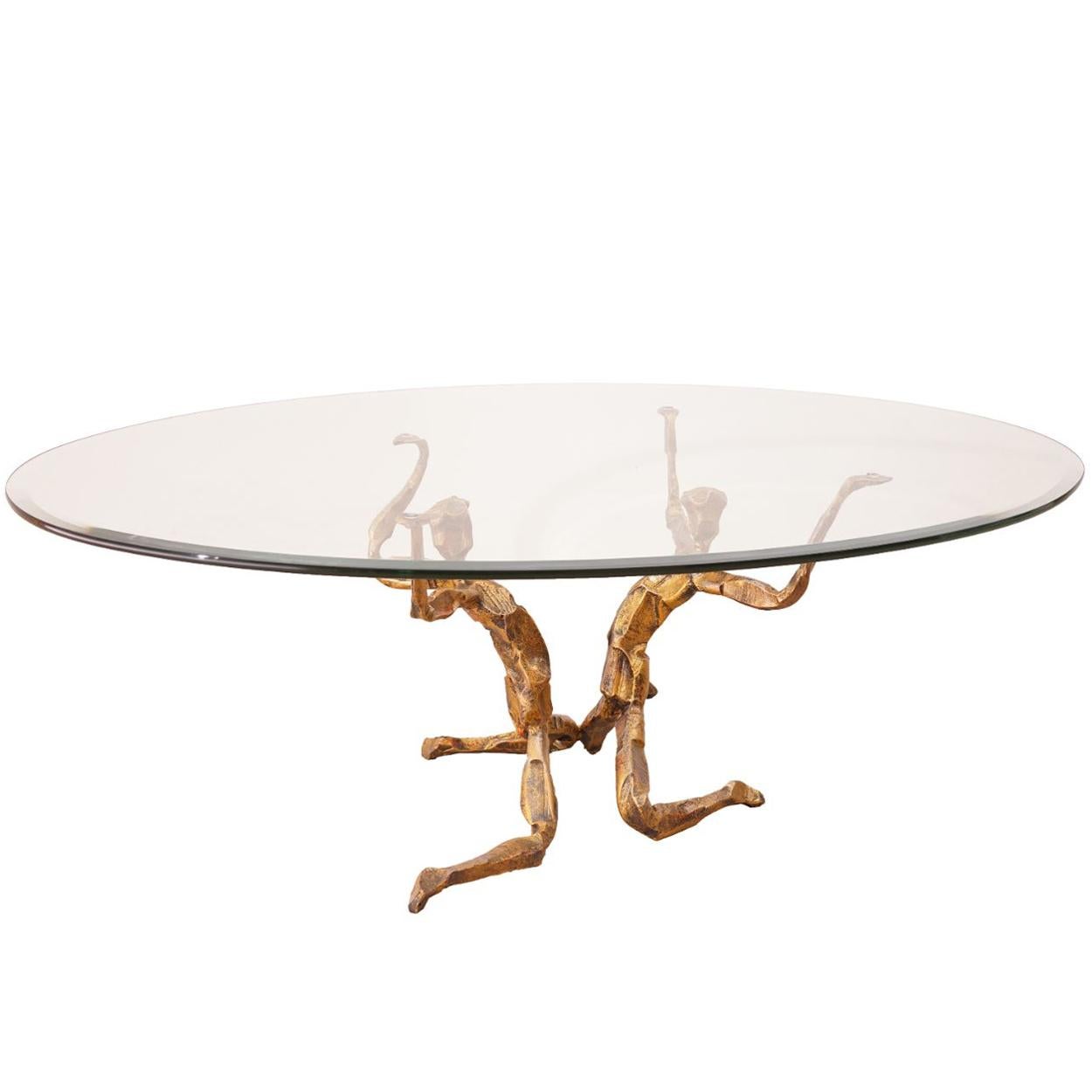 This Brutalist style coffee table was made by Italian artist Salvino Marsura. The table has a gilded wrought iron frame and an oval glass top with a beveled edge. I statement piece! The Marsura signature is printed inside the gilded iron