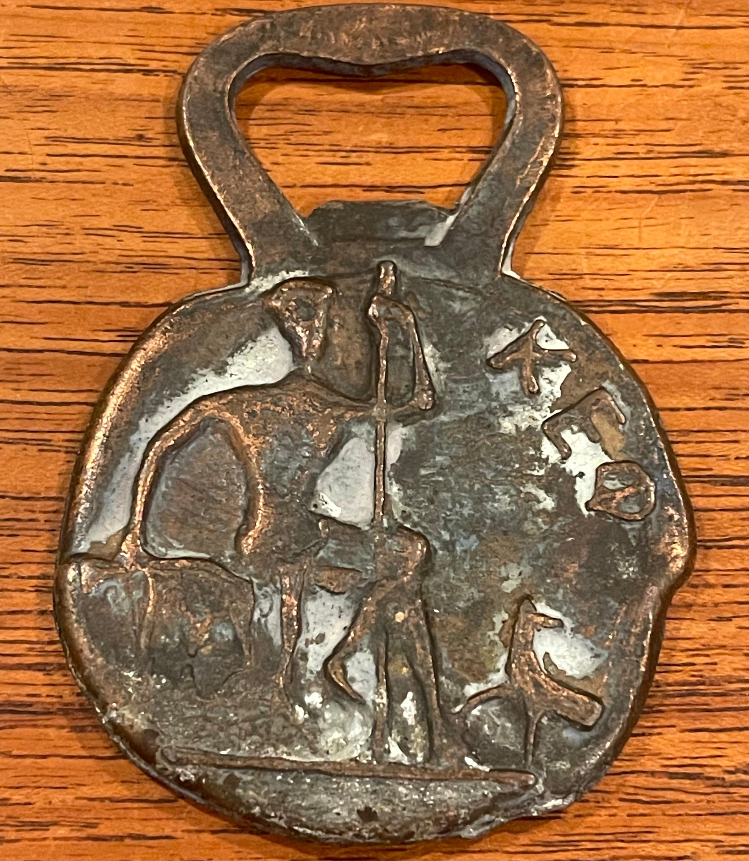 Brutalist style Greek MCM bronze bottle opener, circa 1960s. The piece is in good vintage condition with a great patina and measures 2.25