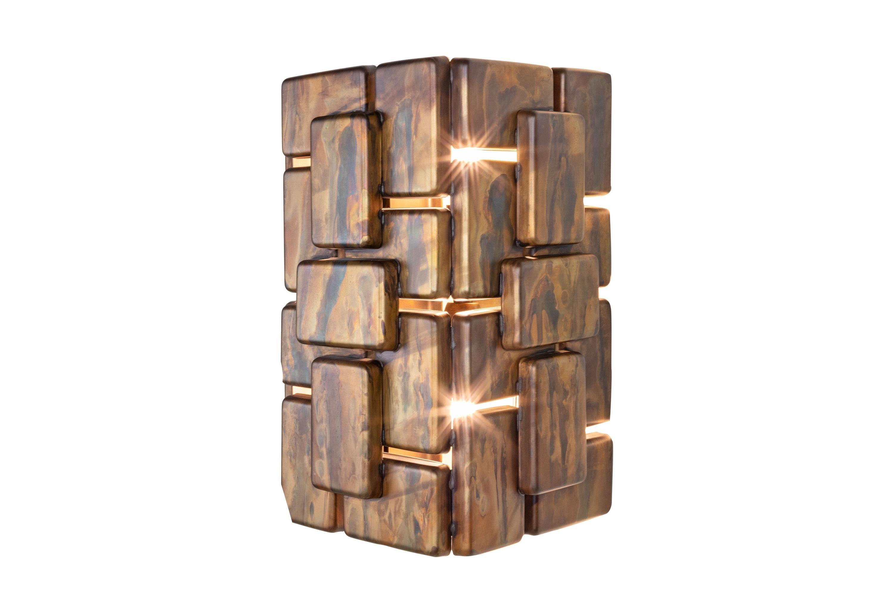 Brutalist and brass metal wall light composed of an aerial structure with oxidized finish.