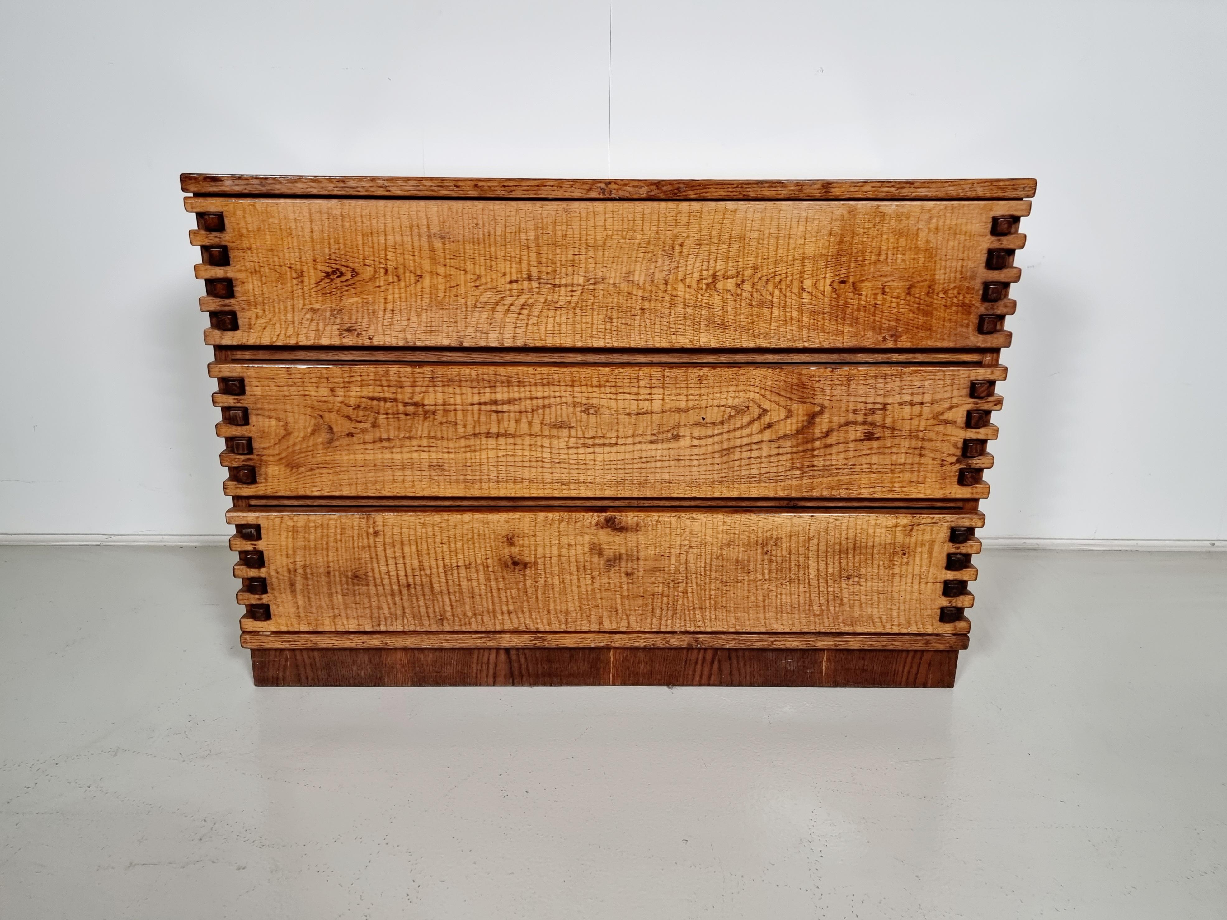 Striking Brutalist solid oak chest of drawers from the 1970s. Designed and made by an employee of the famous Giuseppe Rivadossi factory in Italy. Beautiful details on the drawers. Very good original finish and original condition with very minor