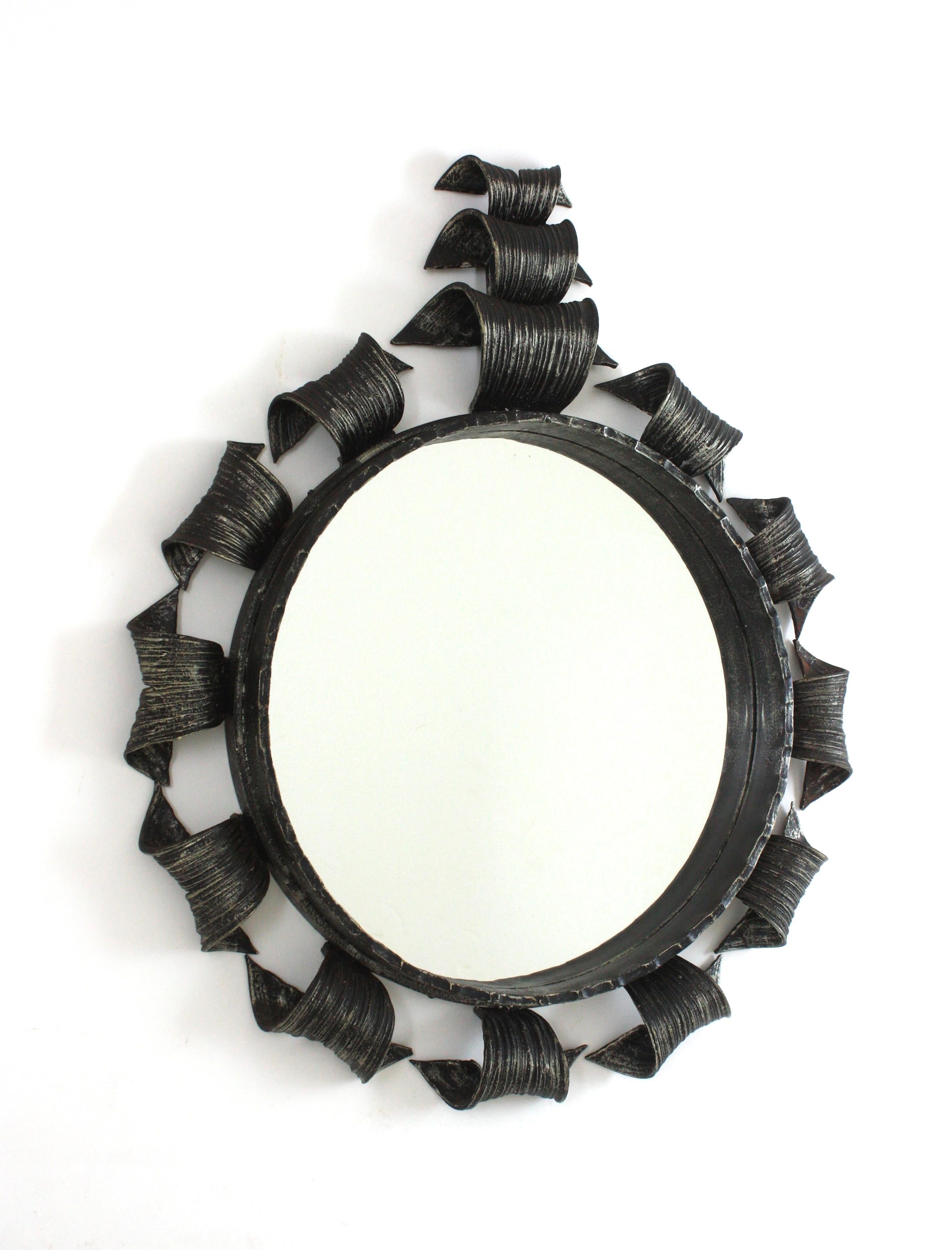 Spanish Sunburst Mirror, Wrought Iron, Silver Patinated
____________________________________________________________________________
Hand forged iron round mirror with scrolled details and crest, Spain, 1950s.
This eye-catching mirror is entirely