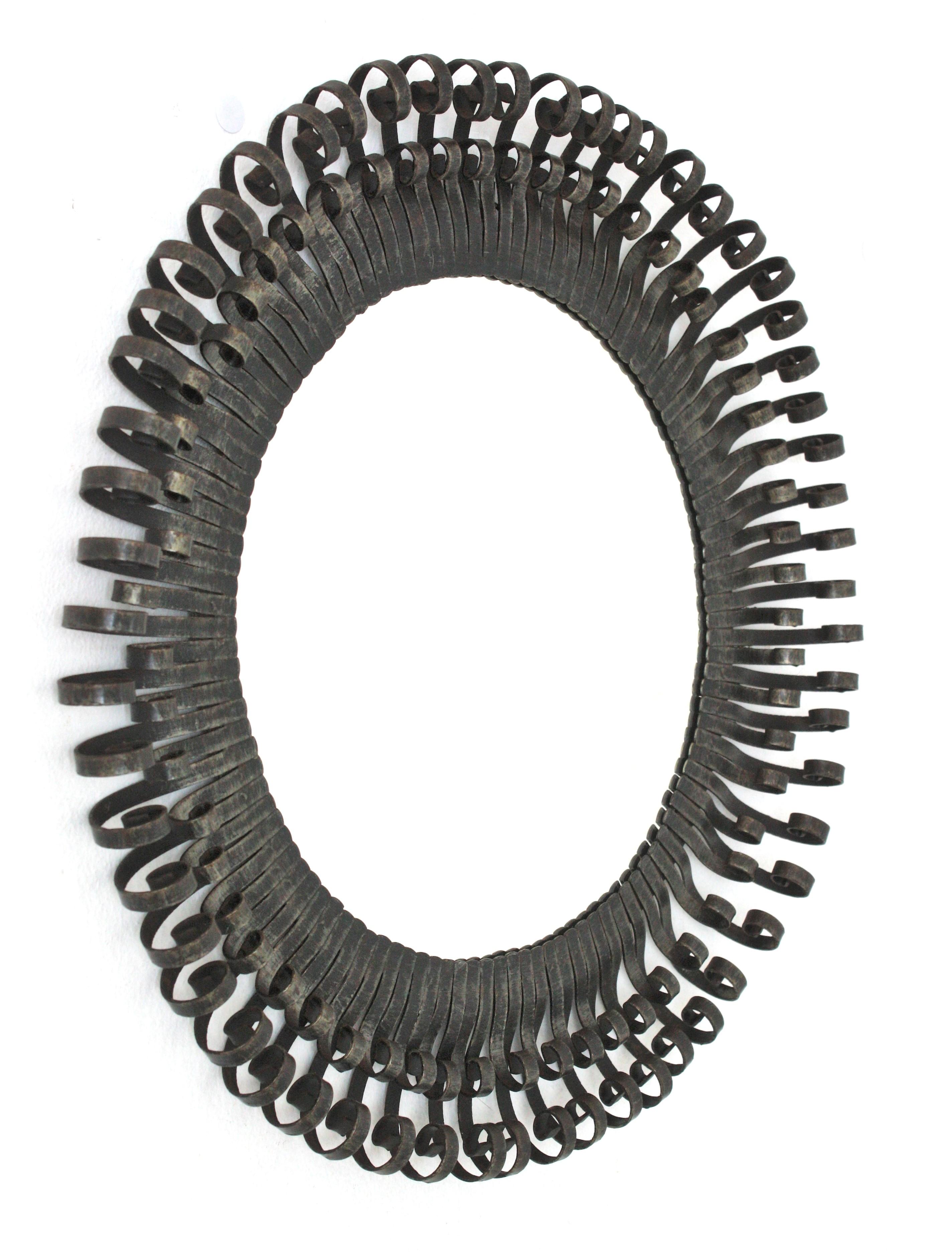 Eyelash Scrollwork Sunburst Mirror / Wall Mirror in Wrought Iron, Spain, 1950s
___________________________________________________________
Eye-catching double layered round sunburst mirror with eyelash scroll endings. 
The frame is made by a double