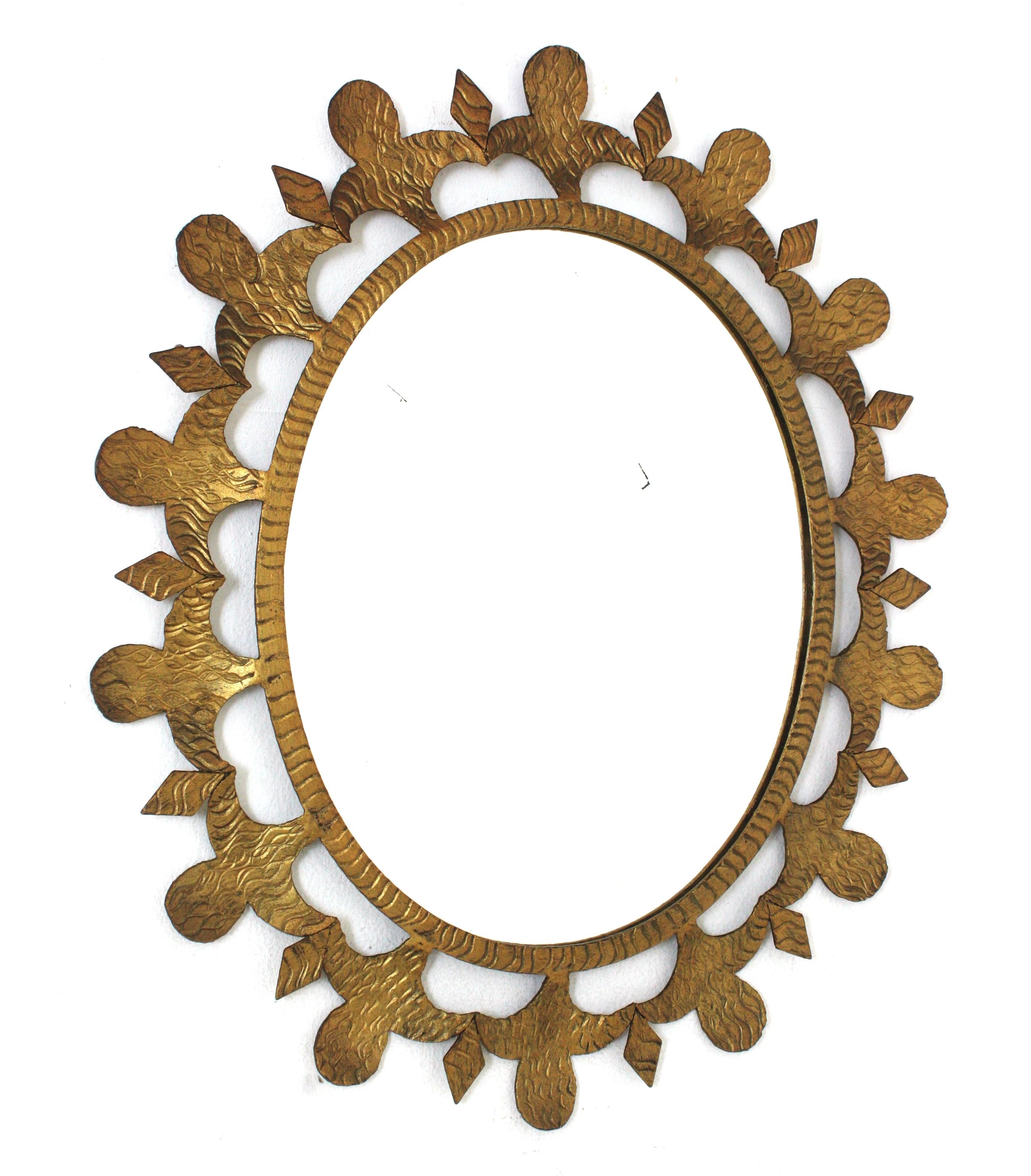 Gilt Oval Mirror, Wrought Iron
Wrought Iron Oval Sunburst Mirror with Scroll Details and Brutalist Design, France, 1950-1960.
Eye-catching hand forged iron mirror with scroll decorations, fleur-de-lis accents and oval shape.
This beautiful oval