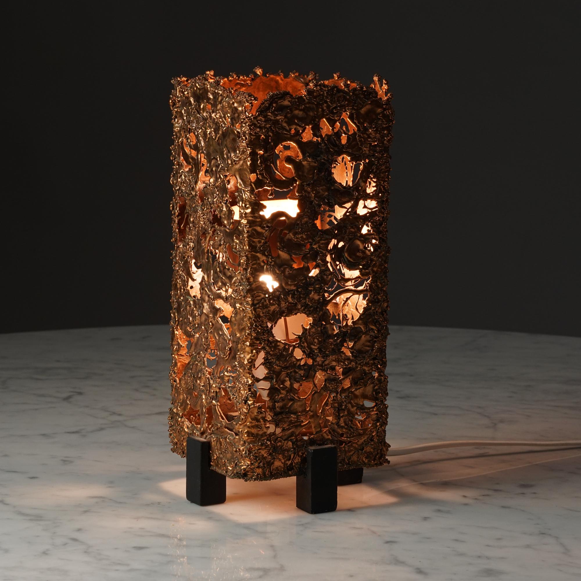 Brutalist Table lamp by Aimo Tukiainen, 1960s, Finland. Melted coppper and wood. This table lamp model is one of the many Aimo Tukiainen designs made of copper. 
Measurments: width 11 cm, depth 11 cm, height 28.5 cm.