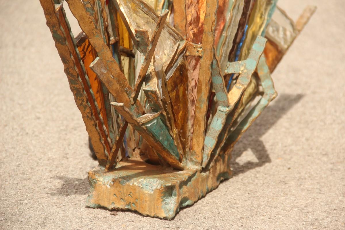 Midcentury Brutalist table lamp gilded iron sculpture often colored glass .

Made entirely by hand in the 1950s in Italy,
in welded and gilded iron, 
large pieces of colored glass wedged between them, 
a sculpture lamp of great effect and of