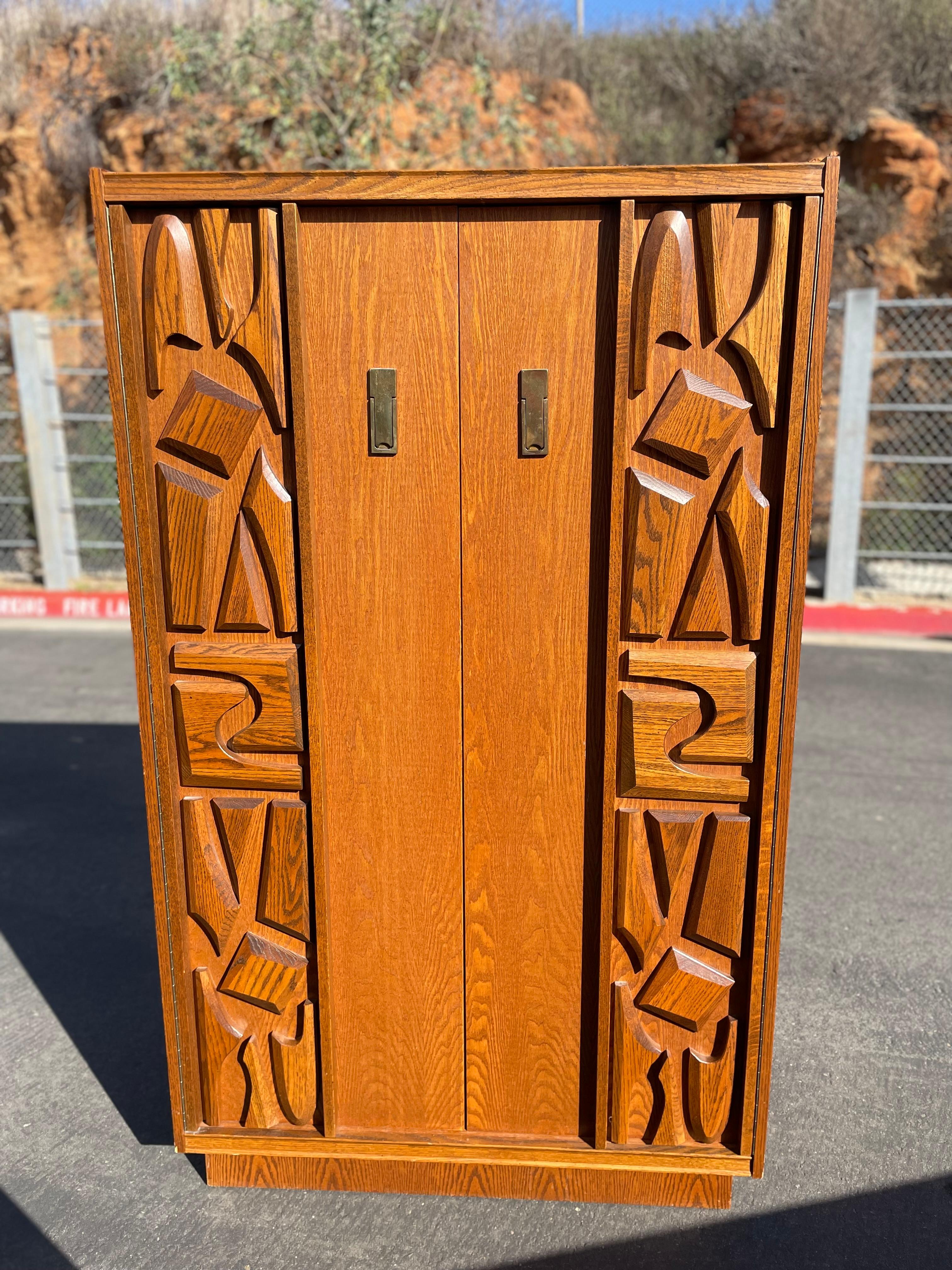 This Canadian brutalist piece is absolutely stunning. Beautifully carved detailing on the front doors. 

Tons of storage space behind the cabinet doors as well as drawer space for additional storage. This could easily be converted to a dry bar to