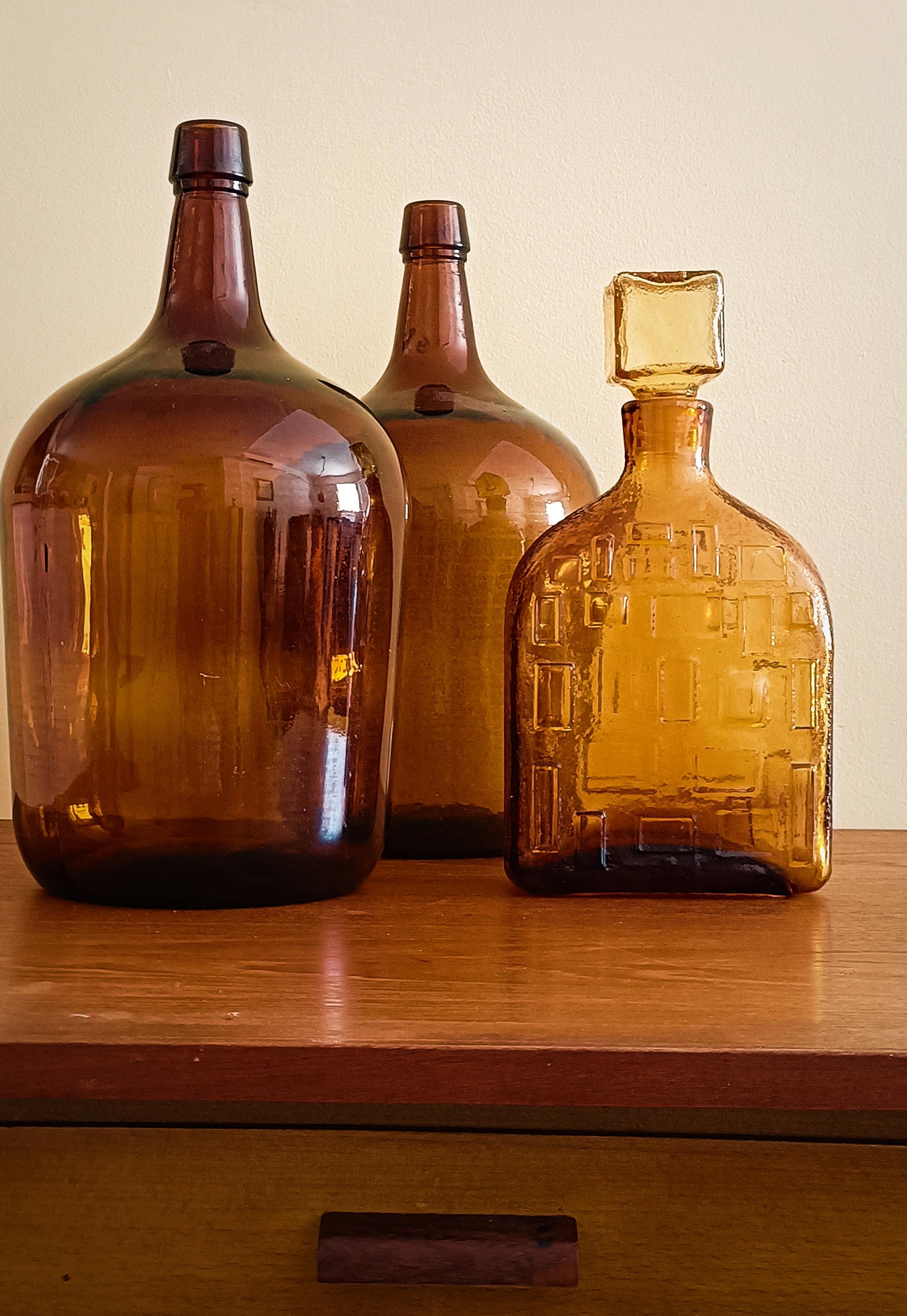 This Brutalist Mid Century pressed glass bottle by Wayne Husted for Stelvia, crafted in the 1960s and marked 
