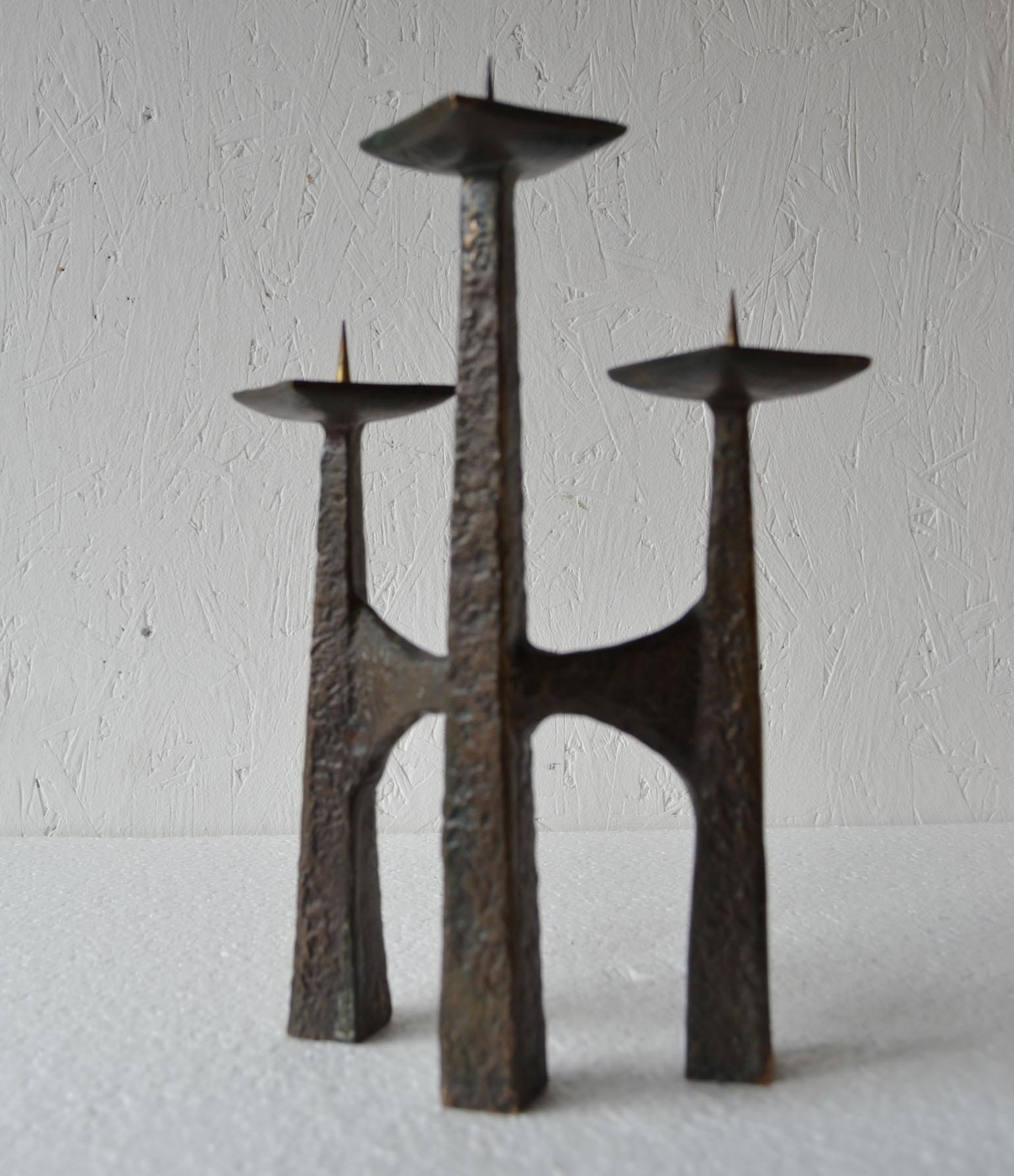 Sculptural three arm candle holder on alternating heights for fat candles (3-4 cm wide) with original dark patina.