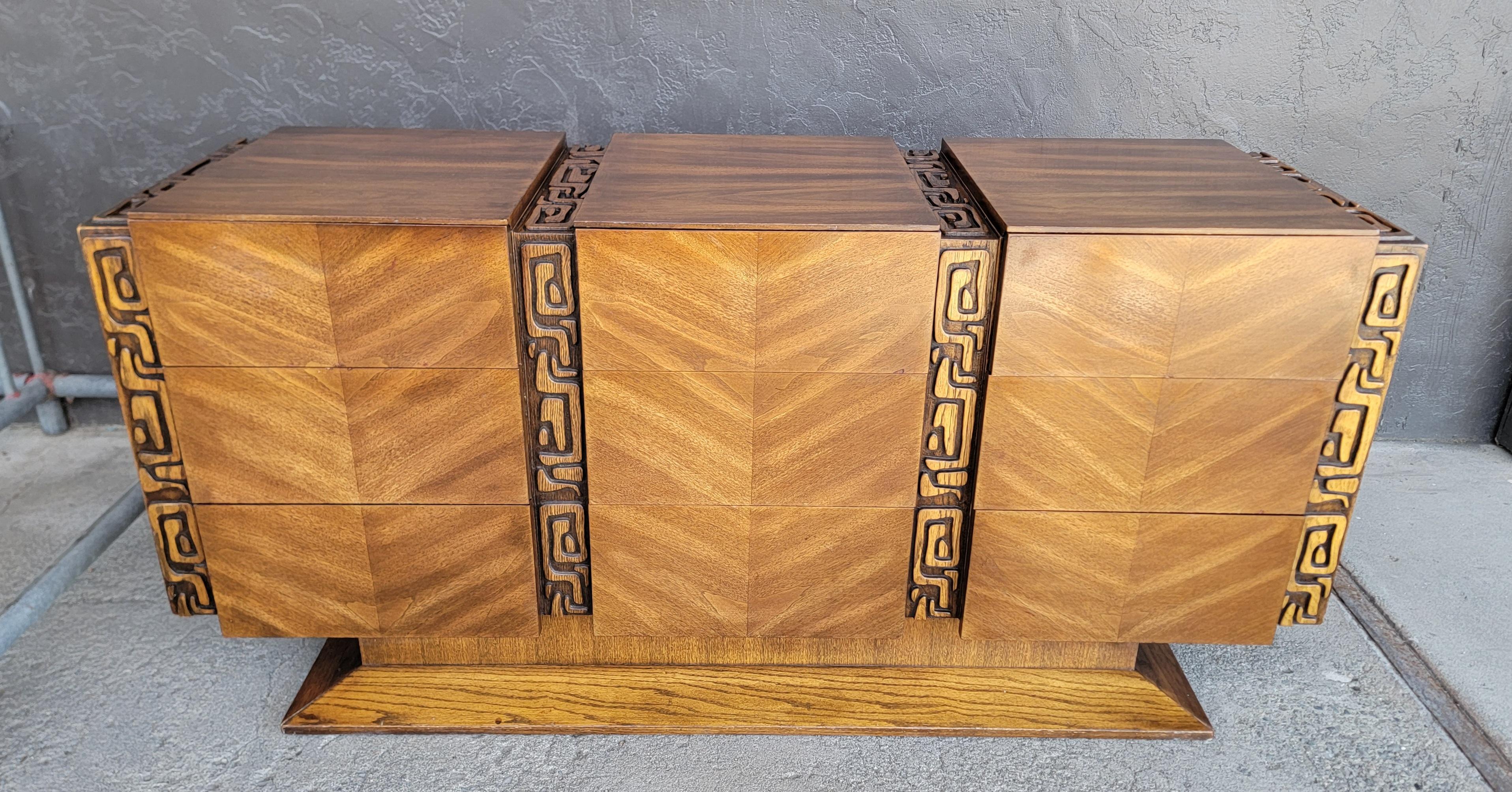 Spectacular 9 drawer low dresser / chest by United Furniture. Brutalist / Tiki style design. Beautiful glow to original finish. Crafted in all wood with book-matched walnut veneer drawer fronts and solid oak interior wood. Very nice original