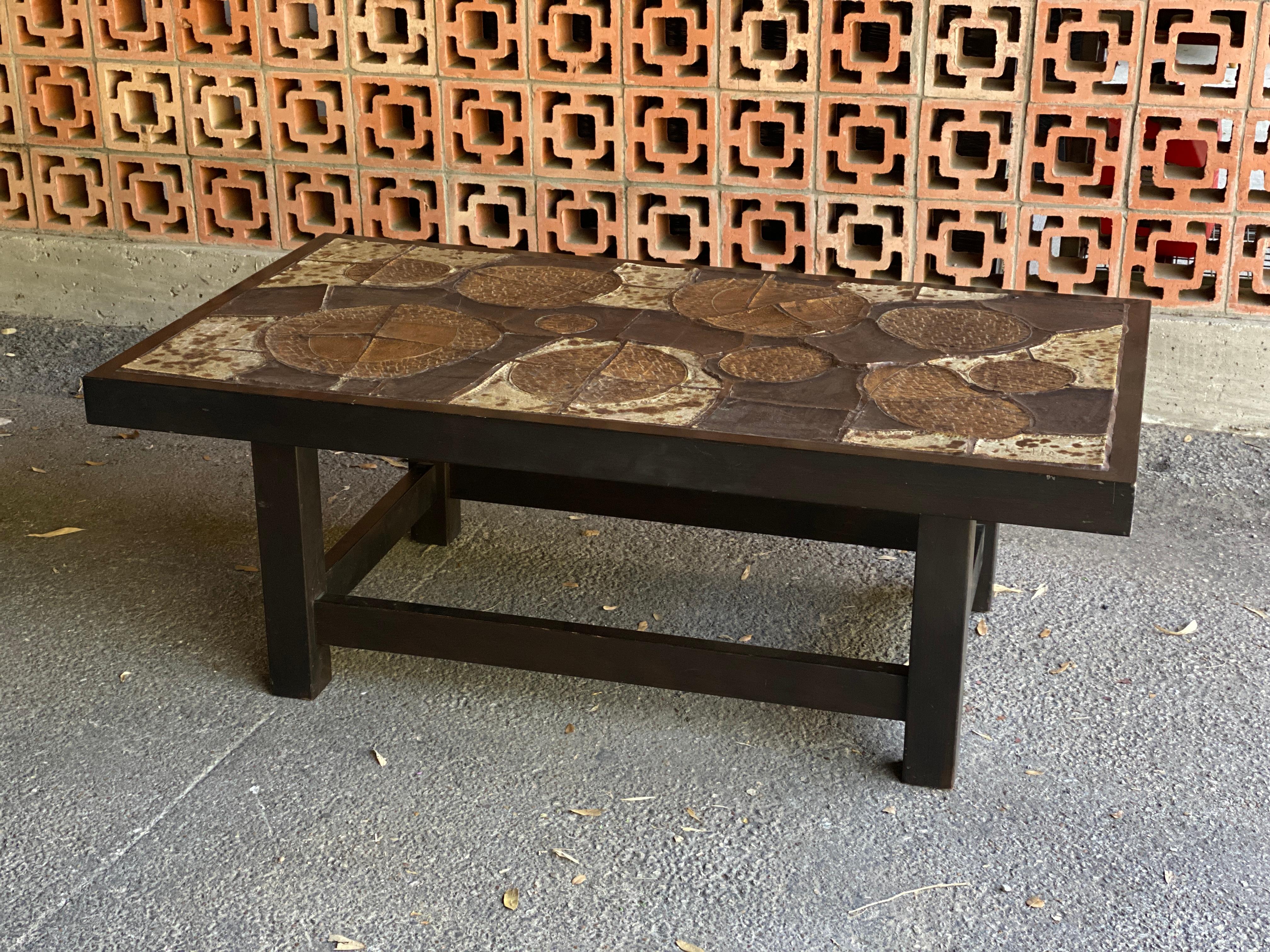 Mid-Century Modern rectangular cocktail table in the Brutalist style with rustic ceramic tile top and wood base (probably stained oak). Matching circular table also available. Signed. Belgium, 1960-70's.