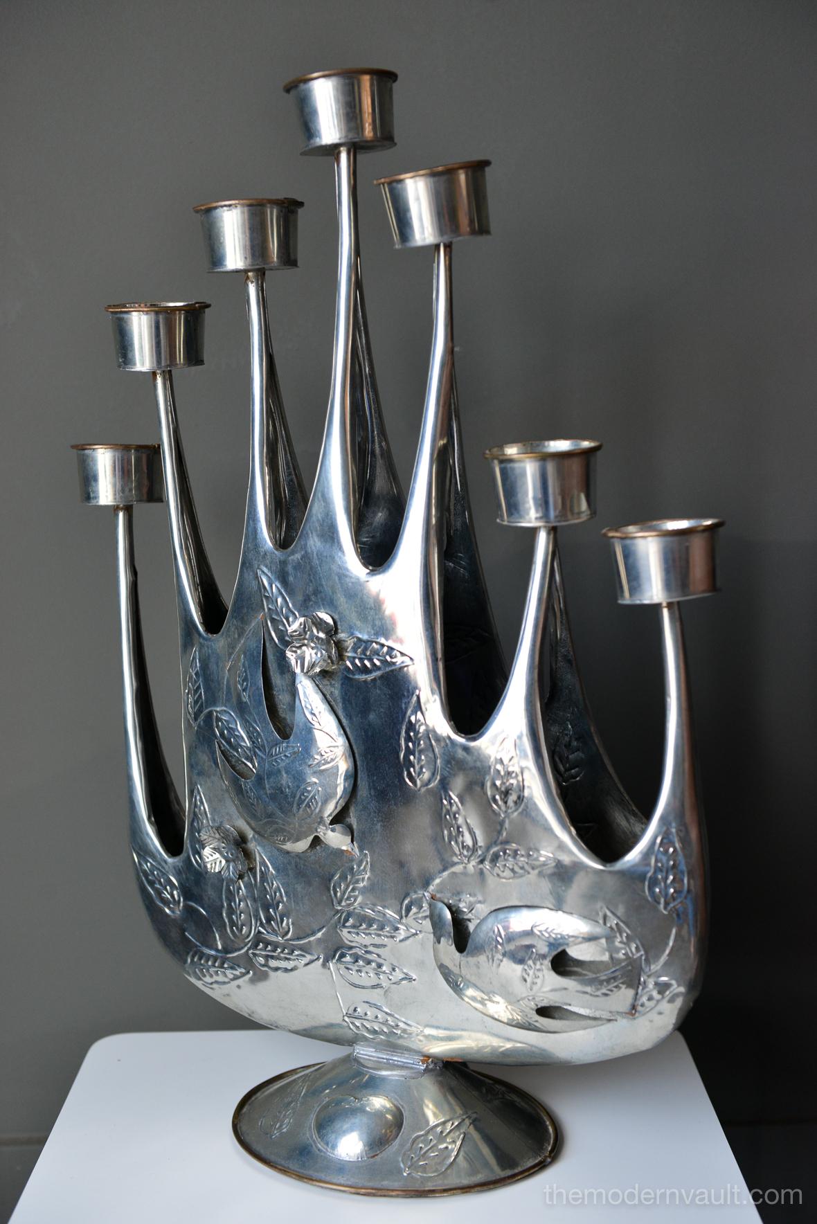 Hammered tin Brutalist tin candelabra by Mexican artist Gene Byron. Handmade of hand-hammered tin with lovely detail, this beautiful piece was also featured in the Verna Cook Shipway Mexican modernism design books of the 1960s. Signed with monogram