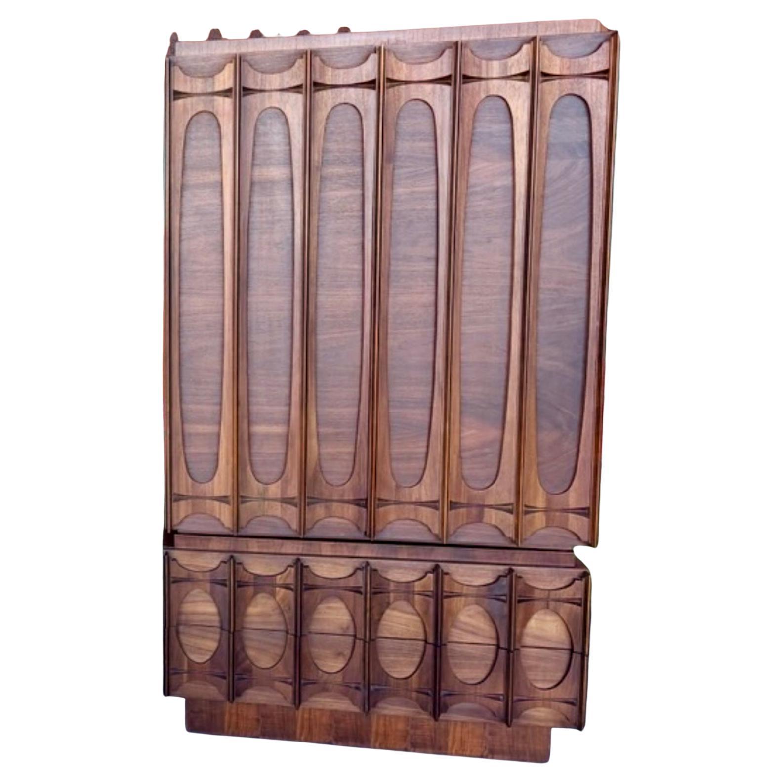 1970’s Brutalist Gentleman’s Chest Dresser by Tabago Canada (aka Tobago). Walnut veneers with beautiful high relief sculptural walnut fronts. Two pieces, topper has double doors that open to reveal three shelves and three drawers. Lower section has