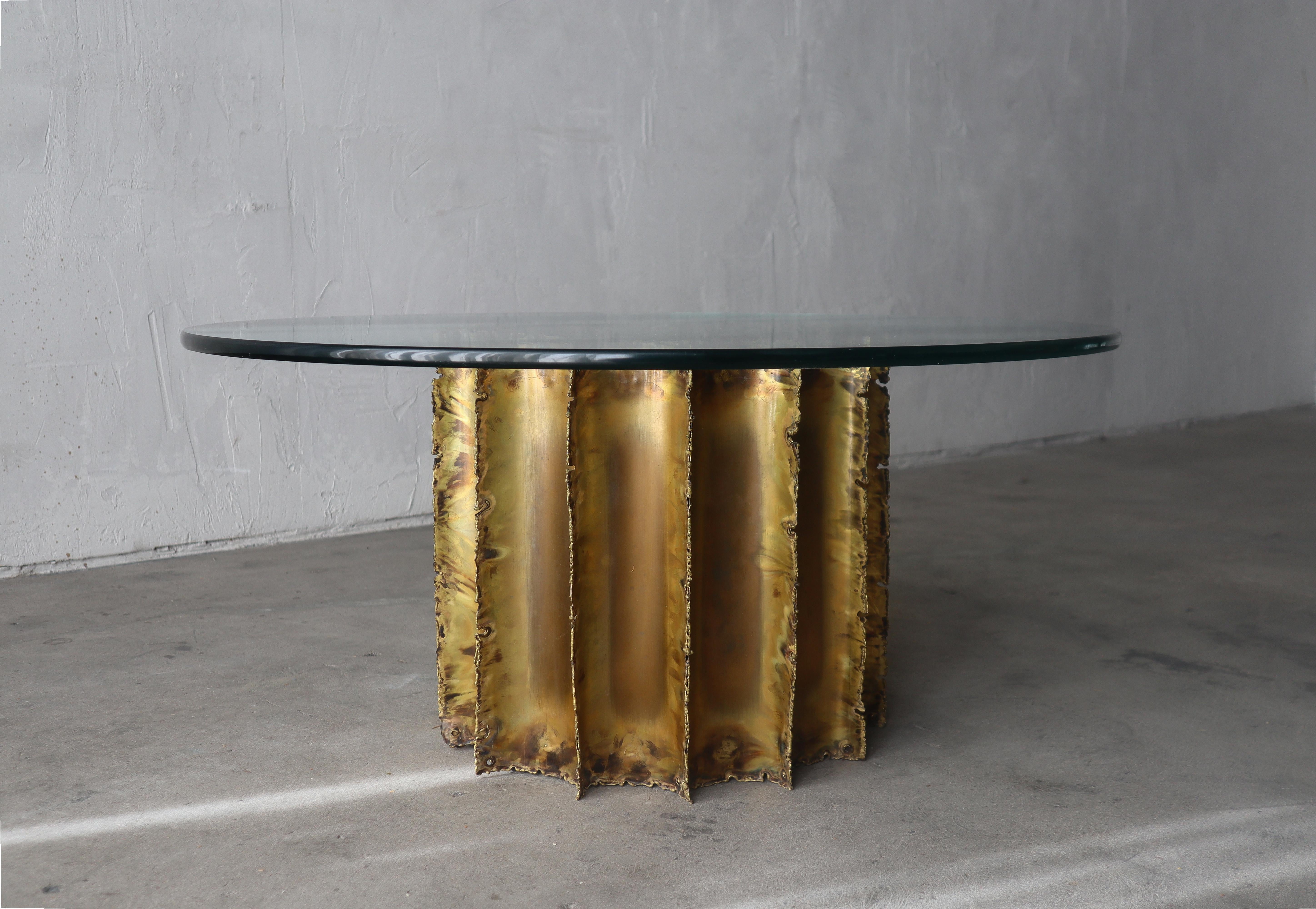 Great Brutalist style, torch cut brass, coffee table base by Tom Greene with nice glass top. These pieces add an elegant, textural element to any space. 

Glass shown is 36