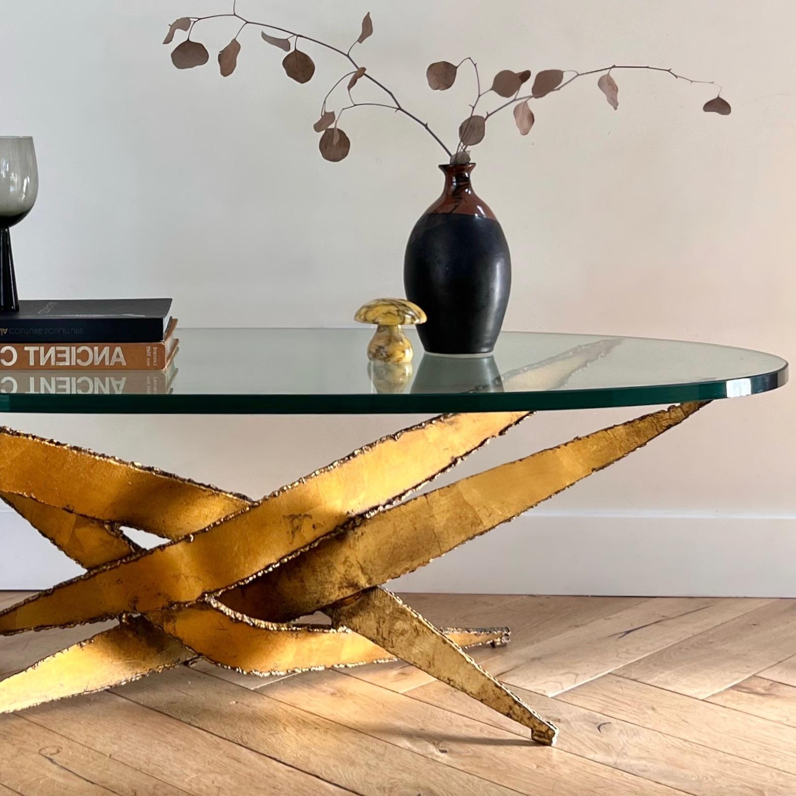 A vintage brutalist torch-cut steel coffee table attributed to Silas Seandel, circa 1970. Oval glass top is original and .75” thick. The metal hails from Mexico as the word “Mexico” has been etched into the base. Signs of age are minor but include
