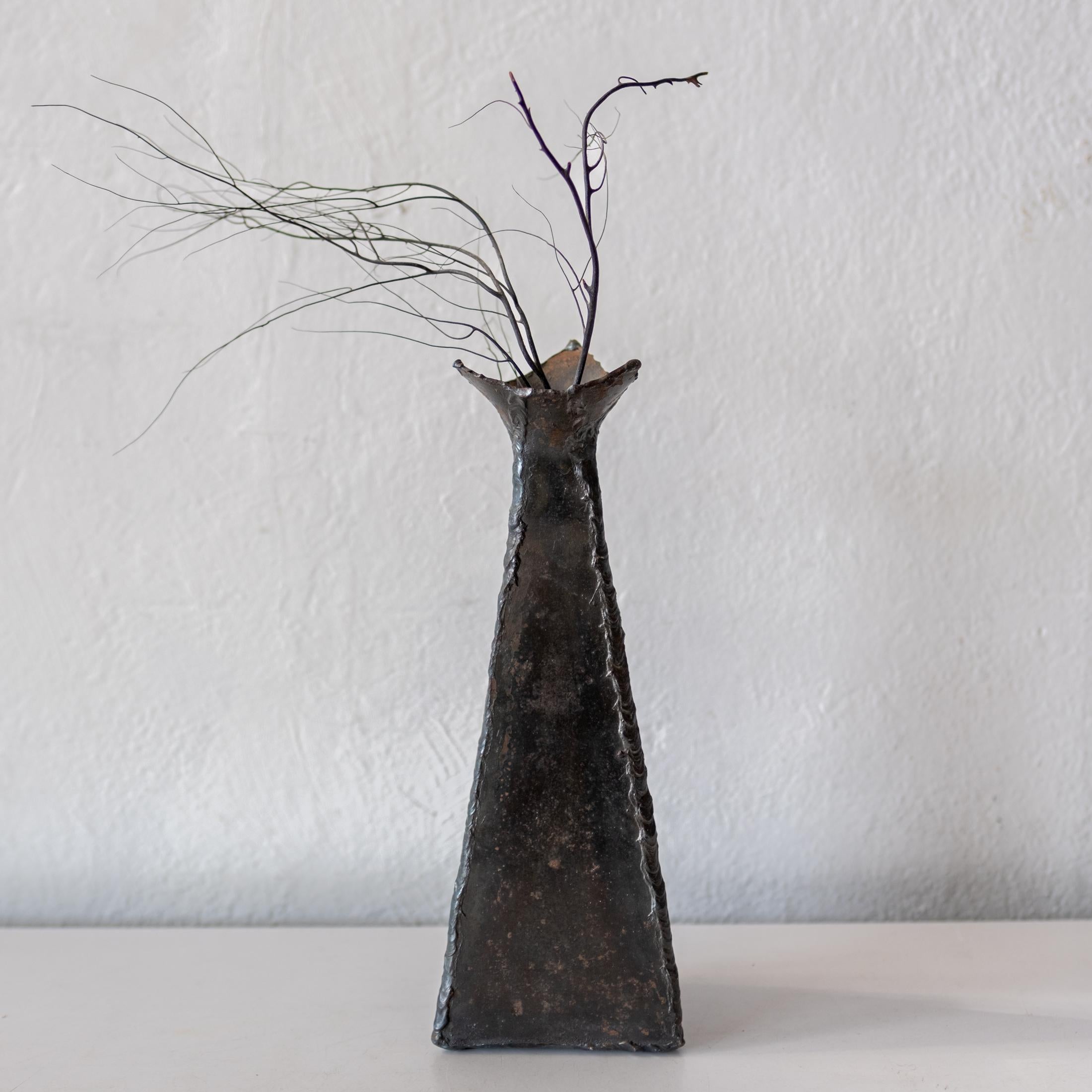 Torch cut patchwork welded steel vase from the 1970s. A nice studio made piece.  Retains the label of the former owner. 