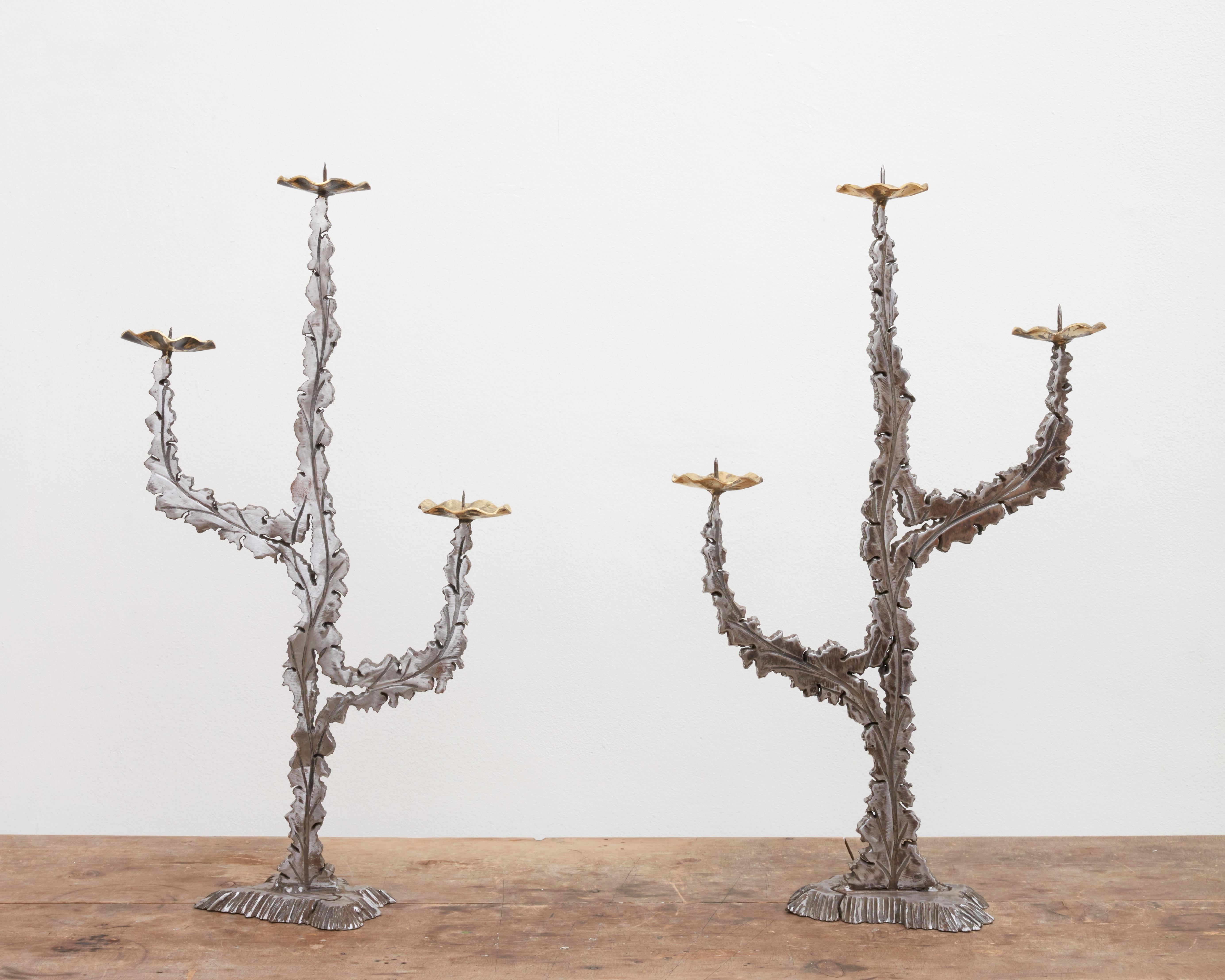 Solid and monumental Brutalist torch cut steel + brass candelabras, France circa 1970's.