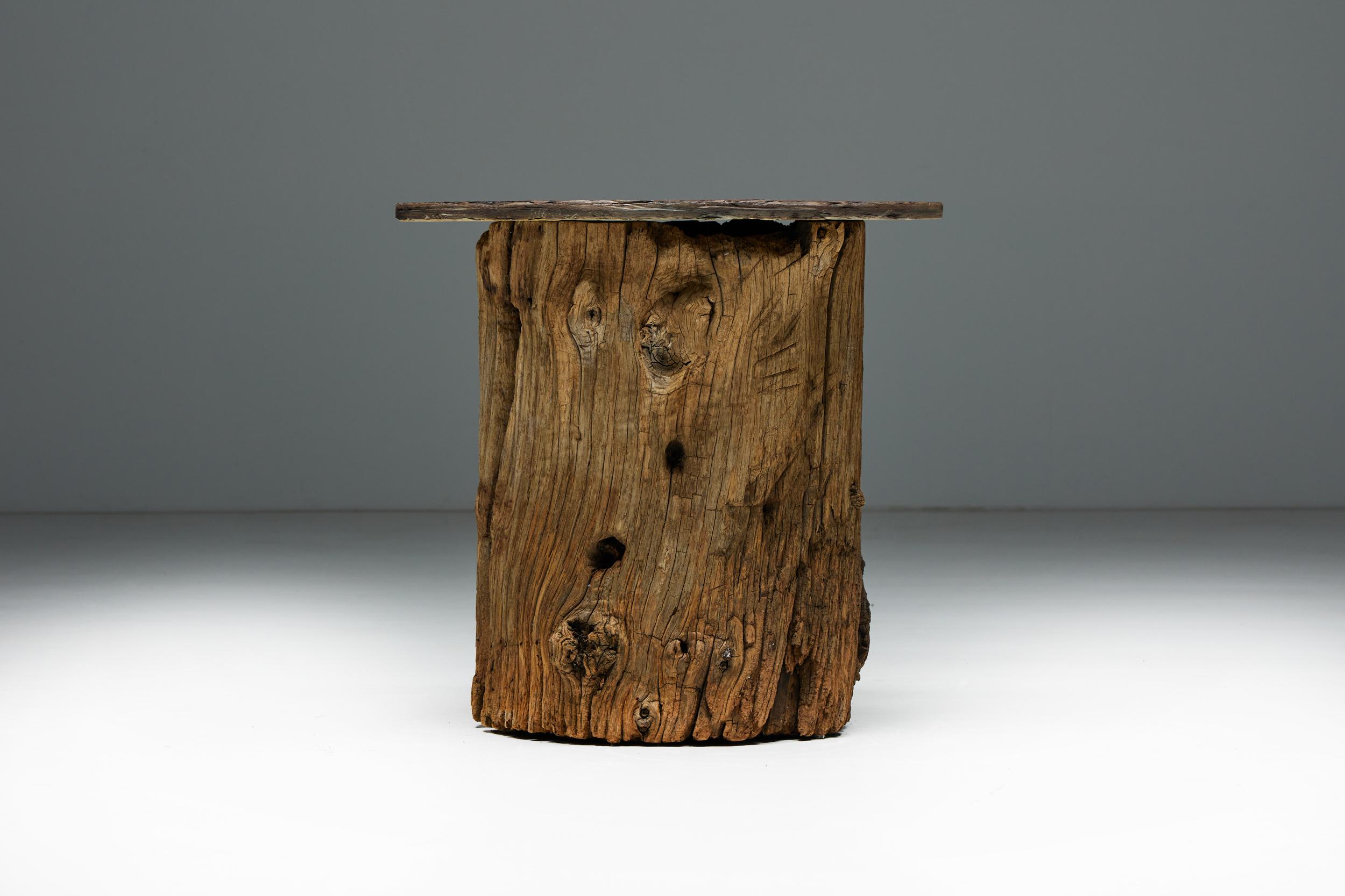 Beautiful side table, handcrafted from a solid tree trunk with a beautiful slate top. This side table is a harmonious fusion of natural beauty and functional design. We have two matching tables available in other offerings, each a masterpiece with