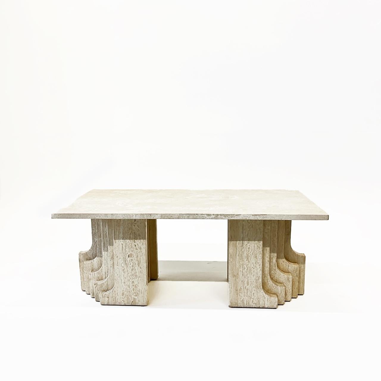 Anchored by two robust, sculptural blocks of travertine. Exhibiting raw textures and subtle tonal nuances, the travertine blocks are reminiscent of the iconic Brutalist aesthetic, with organic sense of movement. The creamy hues of the travertine