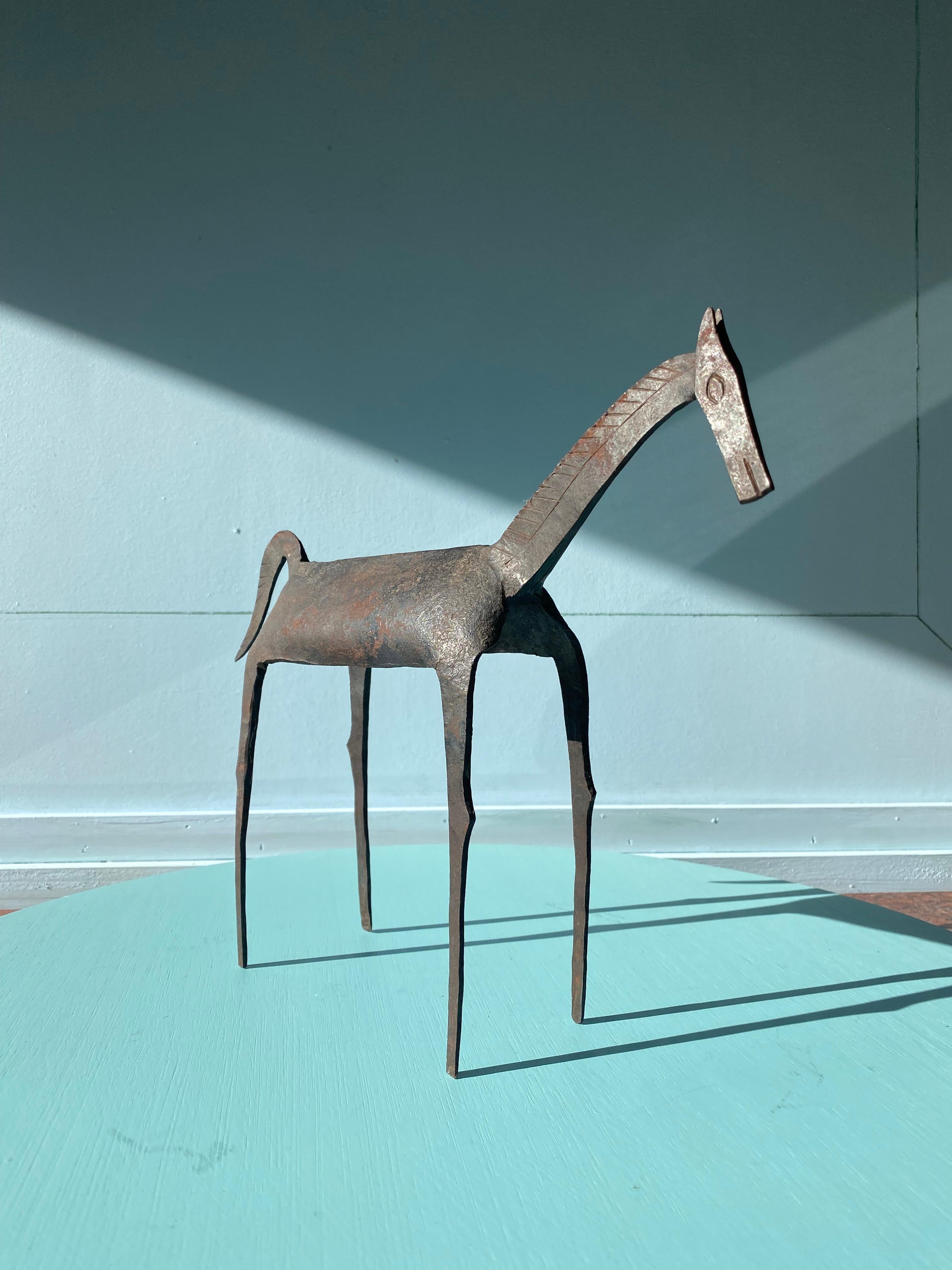A delightful tribal brutalist sculpture of a horse, showing exceptional character and decorative appeal. 

The origin of these figures is disputed. There are arguments made for this type of work as an early 20th Century Dogon tribal production from