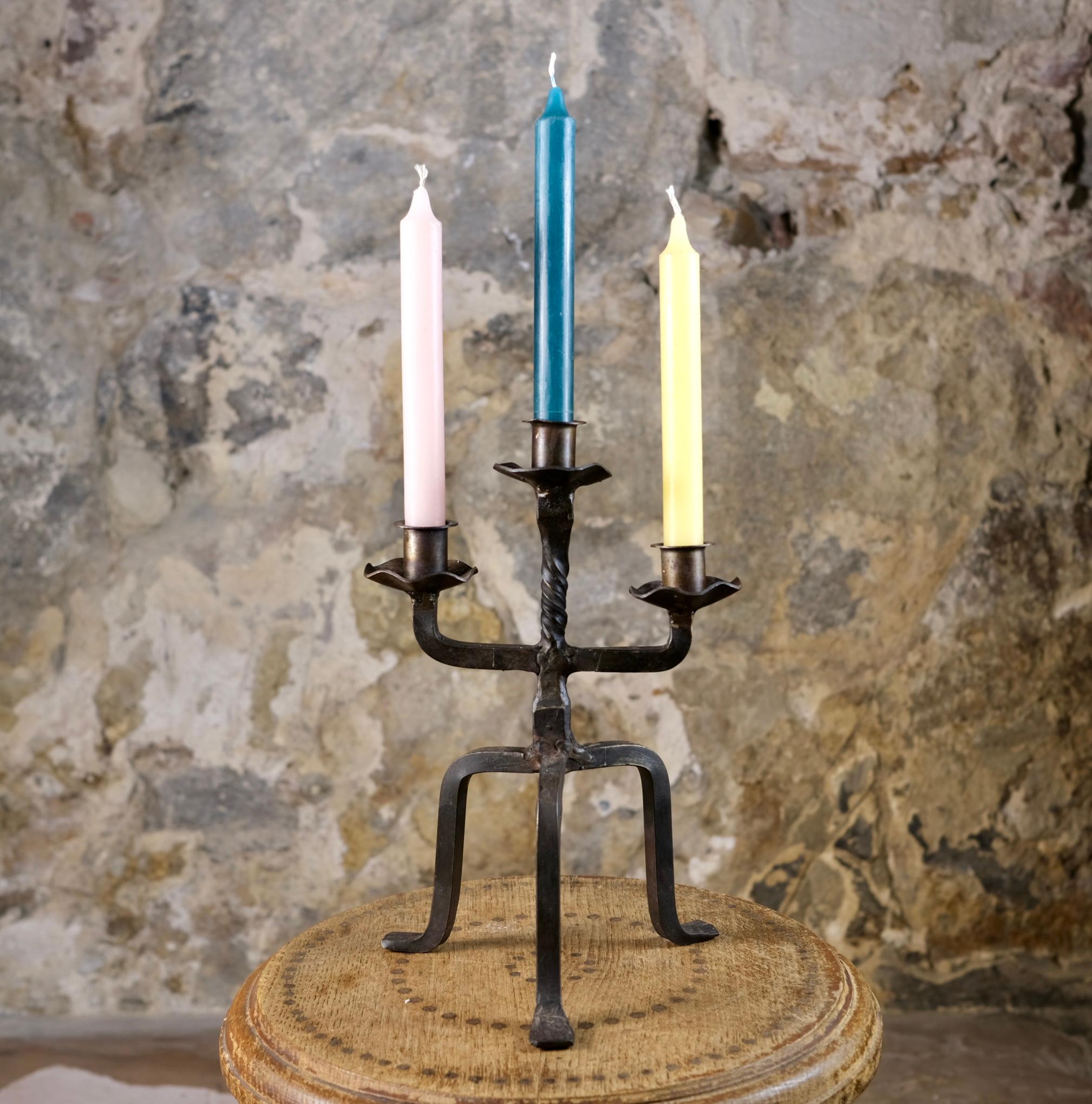 Tripod candlestick made in France in the 1950s, in wrought iron. 
Brutalist style, with nice details (corollas, twist, feet), for 3 candles.
Good condition, nice patina.
Dimensions : W20 D17 H30cm