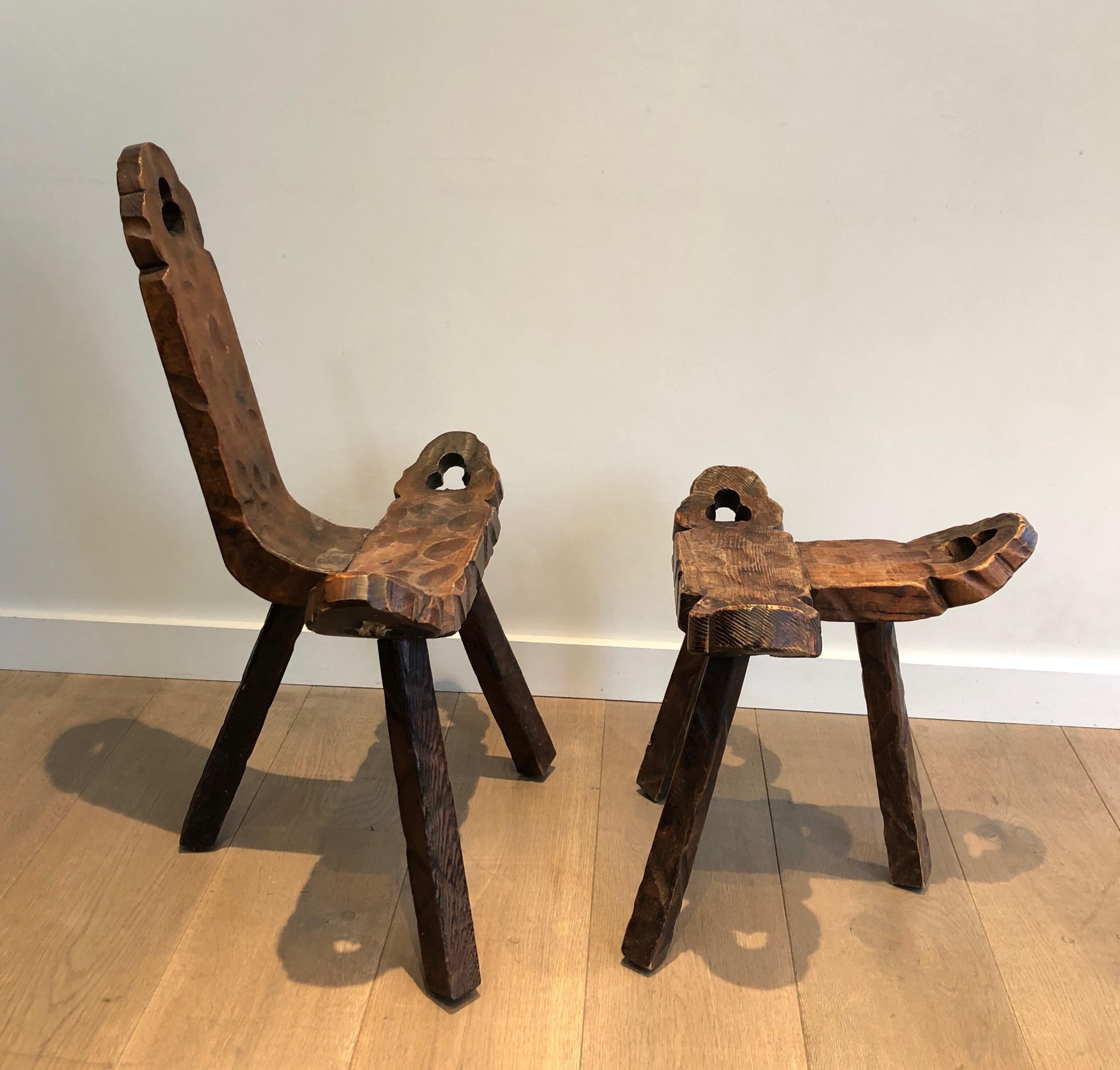 This unusual Brutalist tripod low chair and ottoman are made of wood. This is a French work, circa 1950.