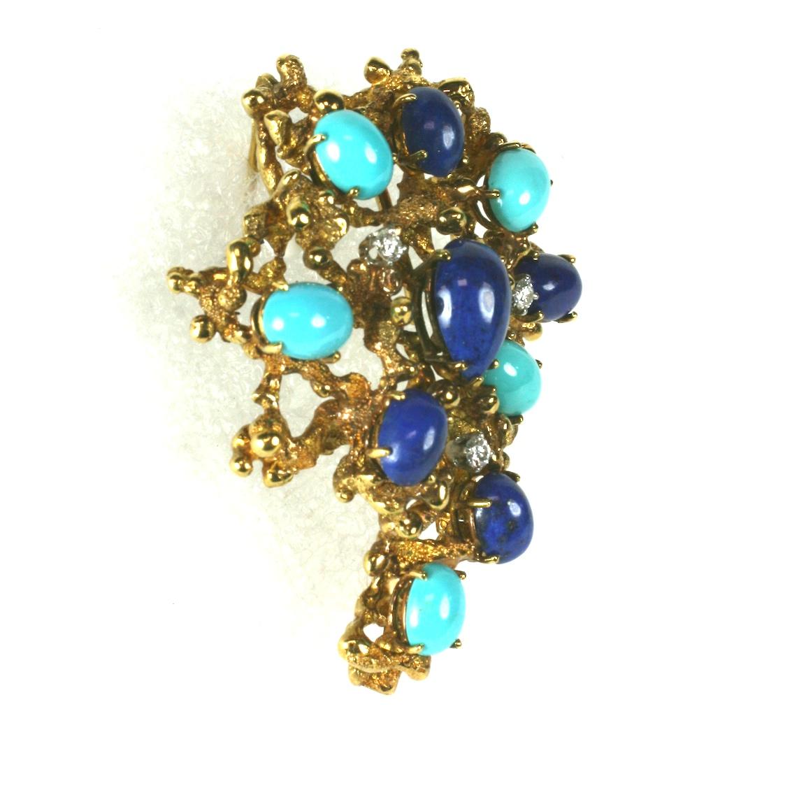 Brutalist Turquoise, Lapis and Diamond Brooch in heavy 18k gold setting. Oval and pear shaped stones are mounted above the dimensional setting with diamond accents.
Interesting, high quality setting. Stones to appear to be sitting on raised bed of