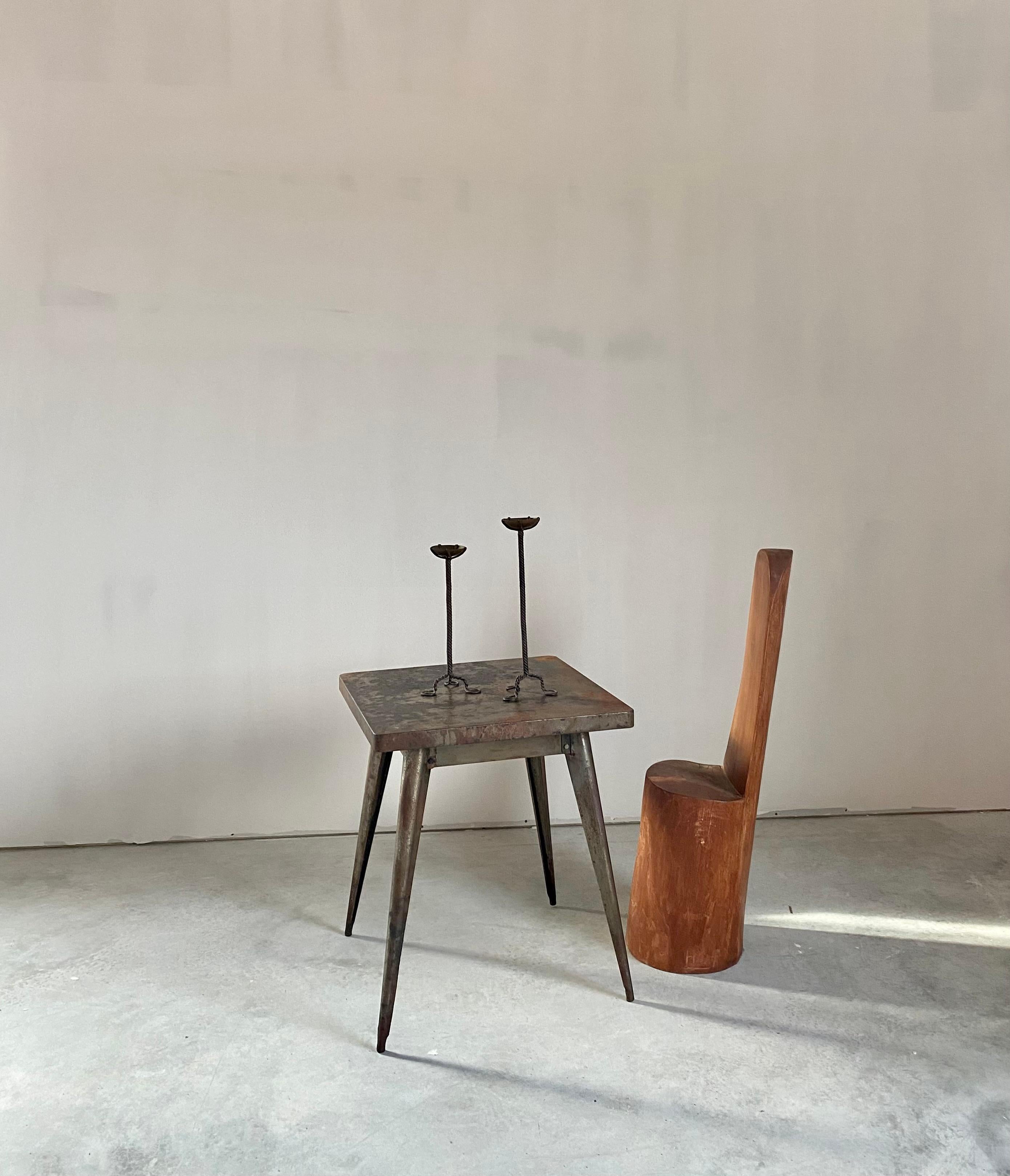 Twisted iron candle sticks in two different heights. Hand-made pieces with the most incredible bases that have a trio of circular 