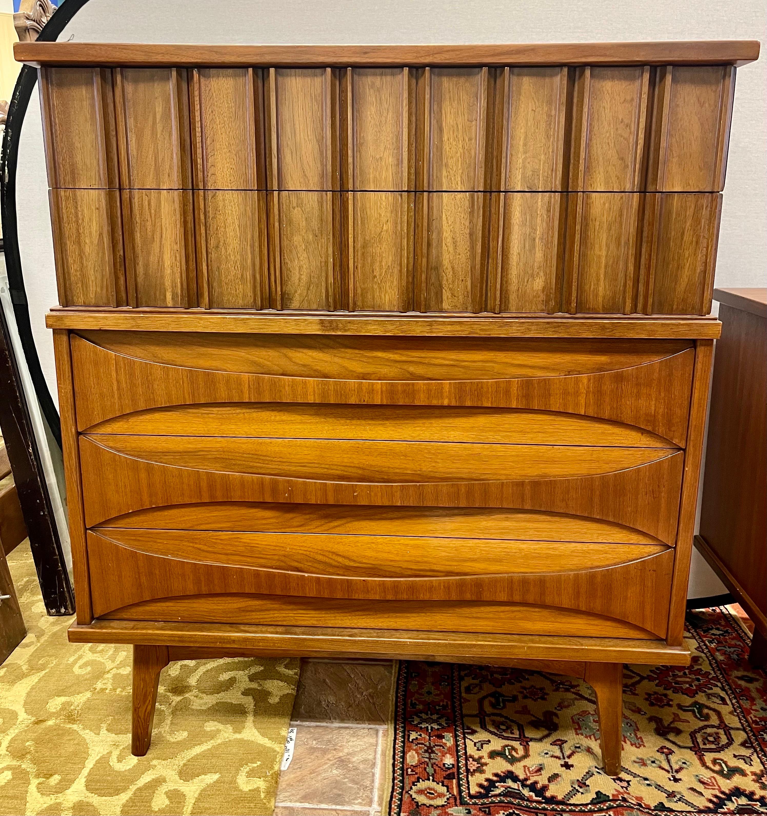 Fabulous sculptural walnut mid century/brutalist dresser made by United Furniture company. This piece features iconic lines and great scale with plenty of storage. Note the coveted carved drawer fronts. Multi-purpose piece at its best.
        