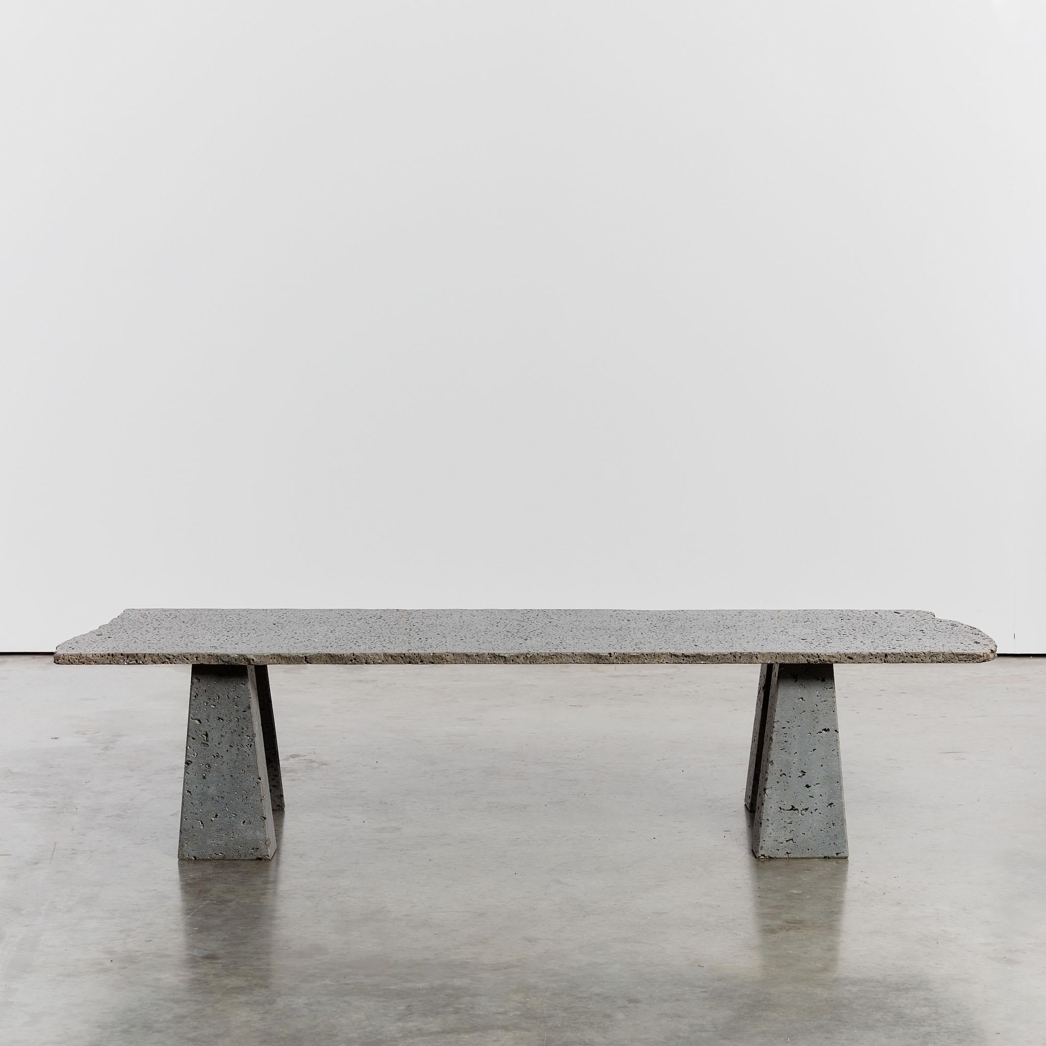 This distinctive brutalist coffee table is made from a slab of porous volcanic stone with a raw edge and four chiseled stone trapeze feet. Rare in both size and form, this piece was discovered in Spain.

Dimensions: L160 x W63 x H37

Condition: Good