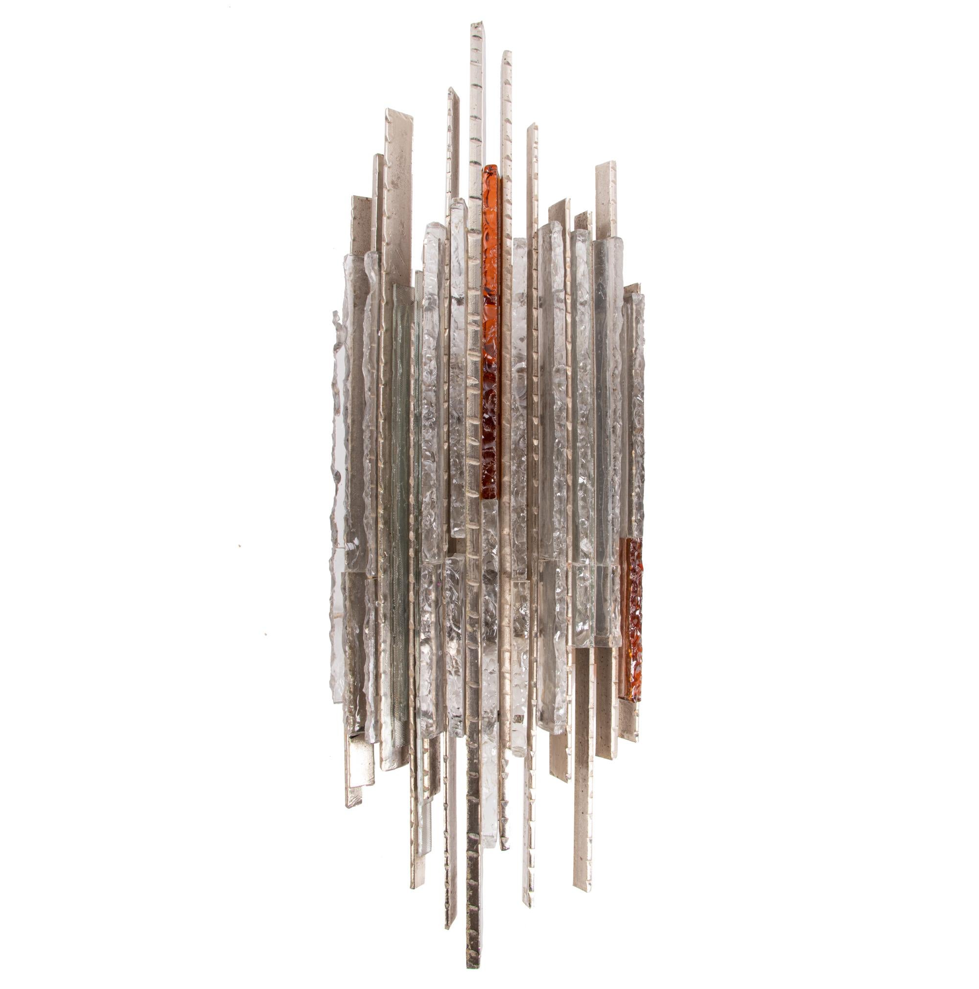 Unique and large Brutalist wall light sculpture made of amber and clear pressed glass mounted on a metal base with lighting mechanism behind. Made by Biancardi and Jordan Arte in Verona in the 1970s. 

Measures: width appr. 11.8