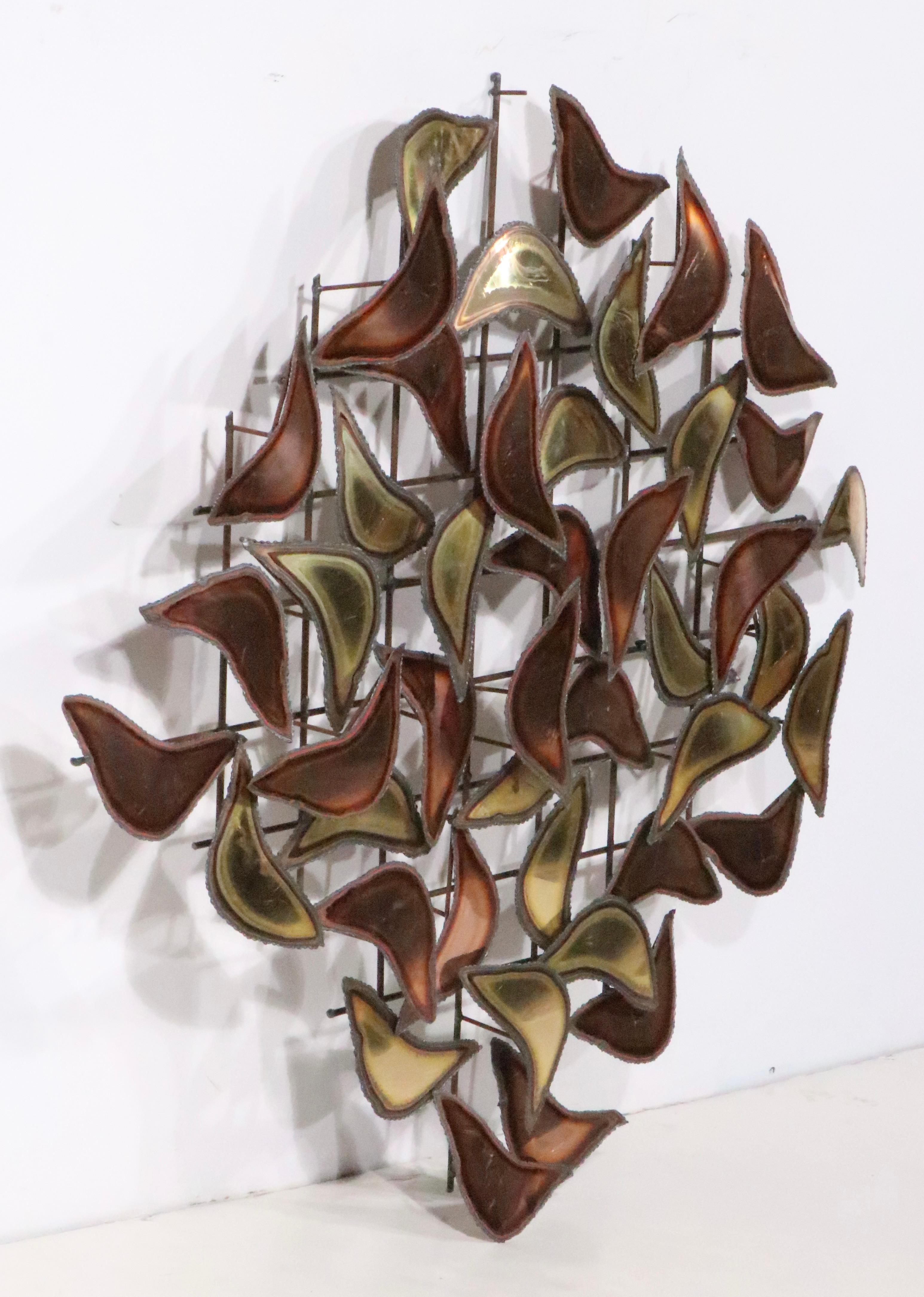 Attractive Brutalist  wall mounted sculpture, attributed to Curtis Jere  circa 1970's.
 The sculpture features repeating copper, and bronze colored organic form shapes, mounted on a grid form back. The piece appears to be missing one tear drop form