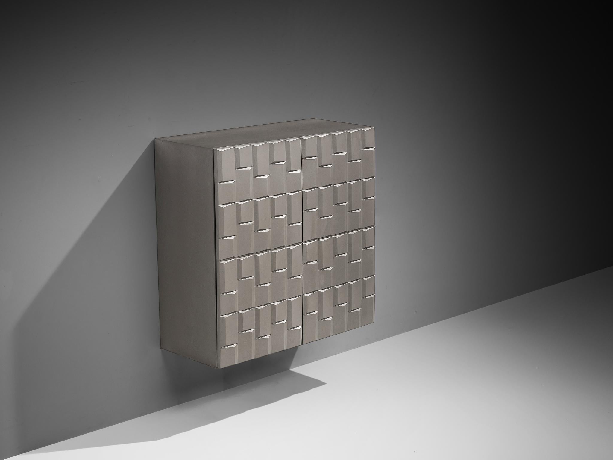 Wall-mounted cupboard, wood, aluminum, Belgium, 1970s. 

This well-designed cupboard features a modern and clean aesthetics based on two-door panels, each with an exceptional three-dimensional pattern. The continuous pattern gives this cabinet a