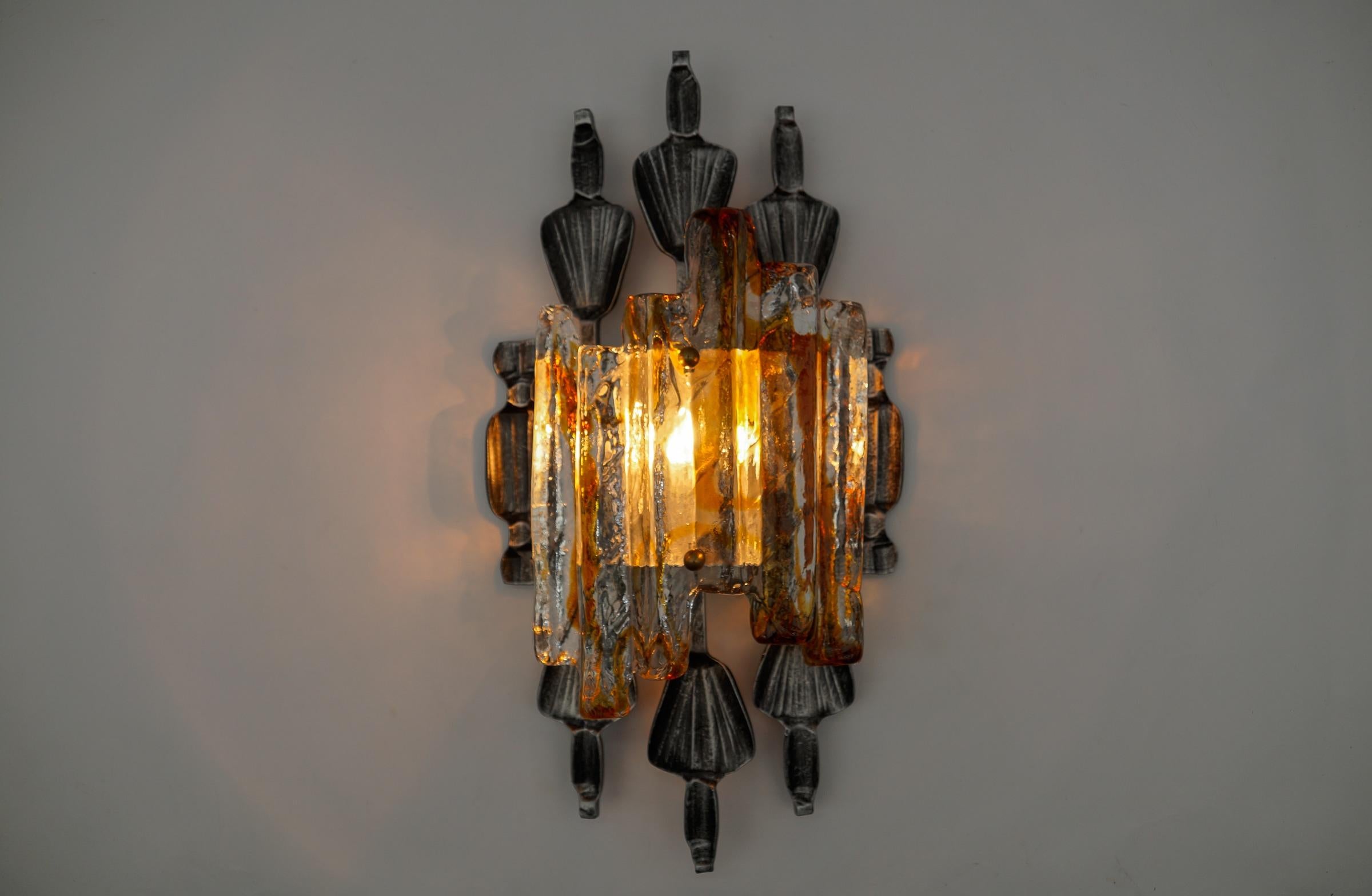 Brutalist wall sconce by Tom Ahlström & Hans Ehrlich, Sweden, 1960s

With a E27 bulb.

A absolute strong and sculptural design!

The handwrought iron surround has a good patination and is set off by the Murano ice glass with its clear and amber