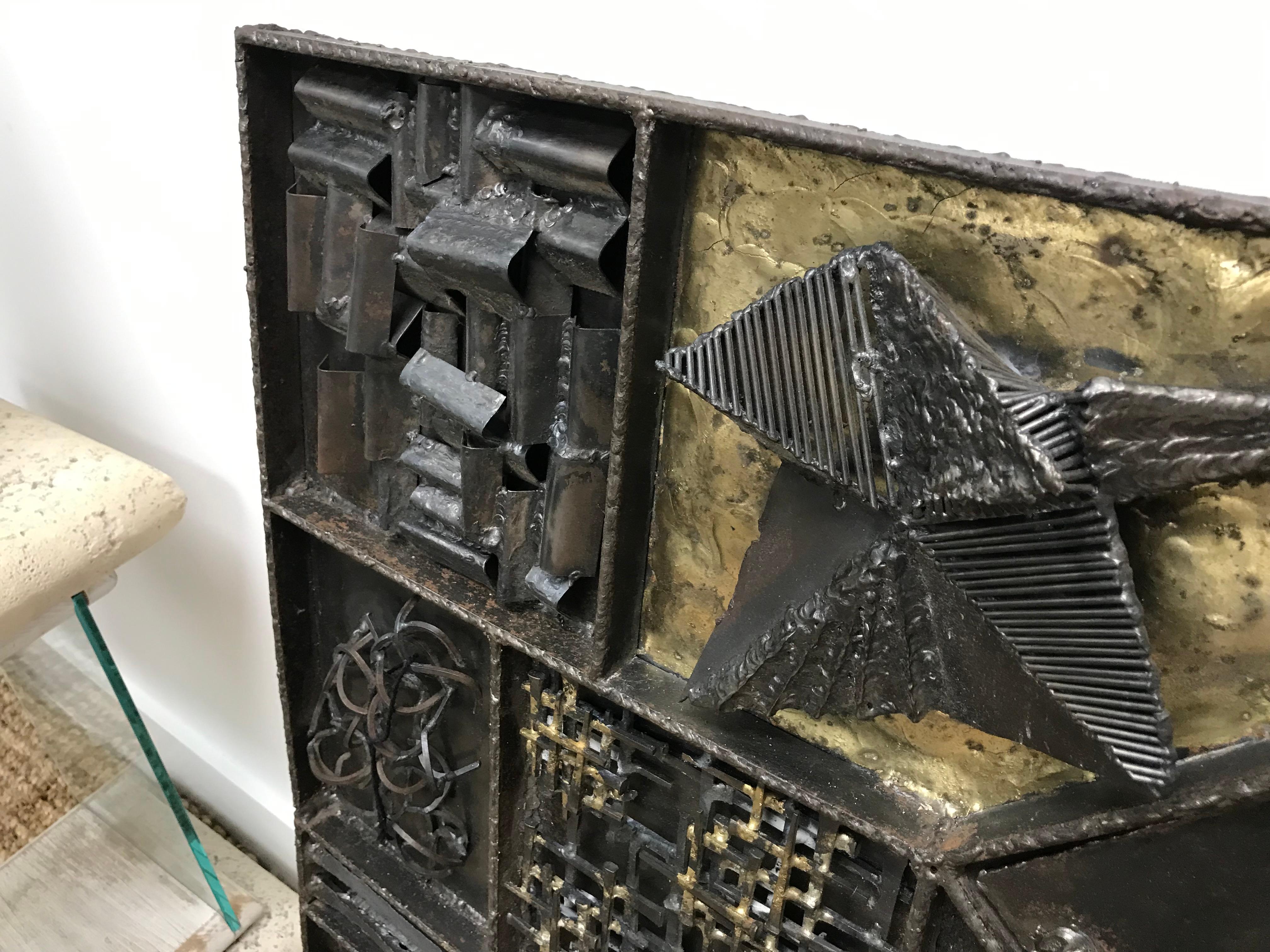 This vintage Brutalist wall sculpture, dating to the Paul Evans era, is a striking and meticulously crafted three-dimensional piece. Although not attributed to Evans, it captures the bold, industrial aesthetic that defines the period. The sculpture