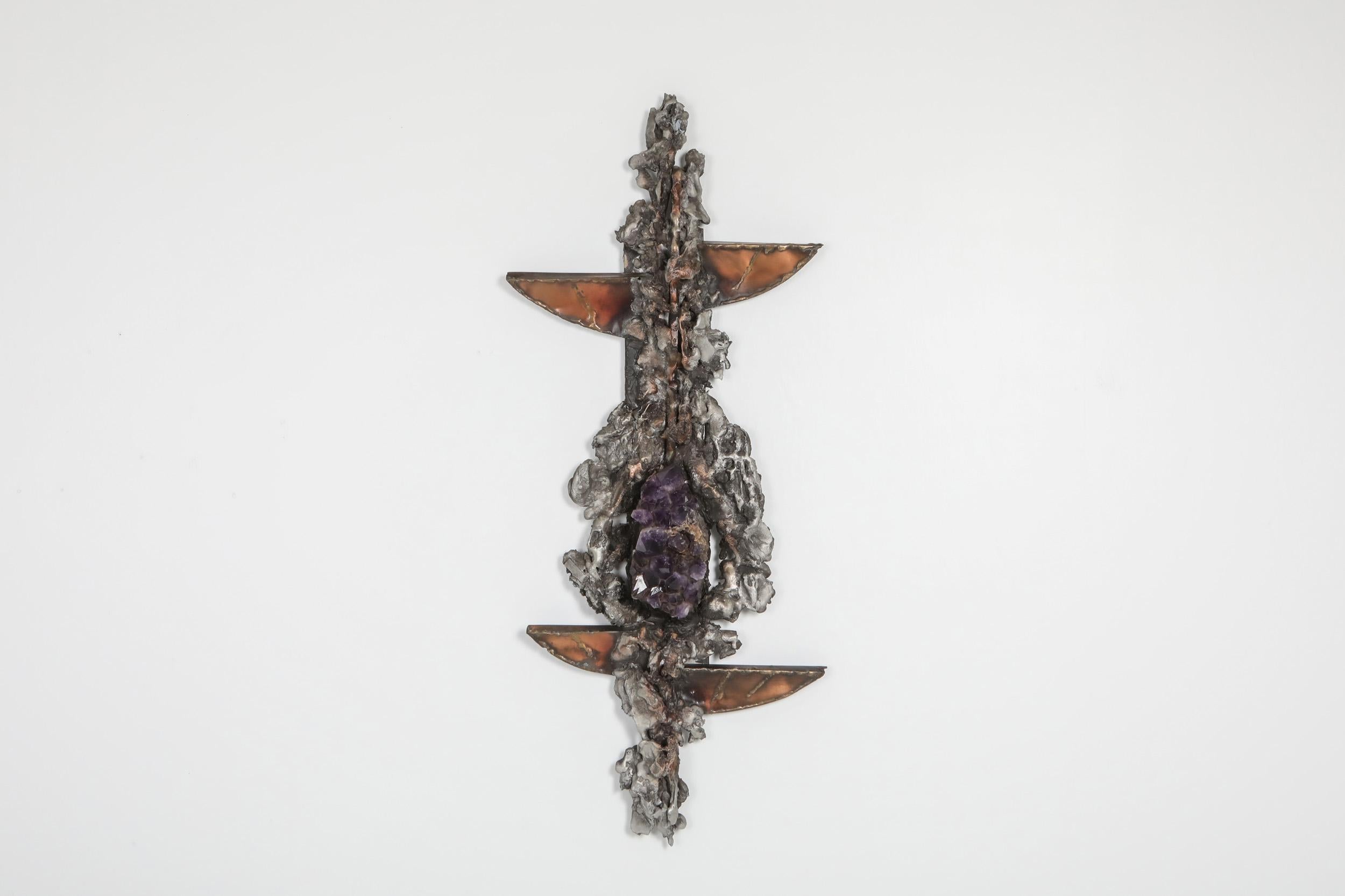 Art sculpture by Marc D’haenens, the 1970s.

The piece shows a variety of organic shapes in metal and copper, and a large piece of Amethyst as centerpiece.
 