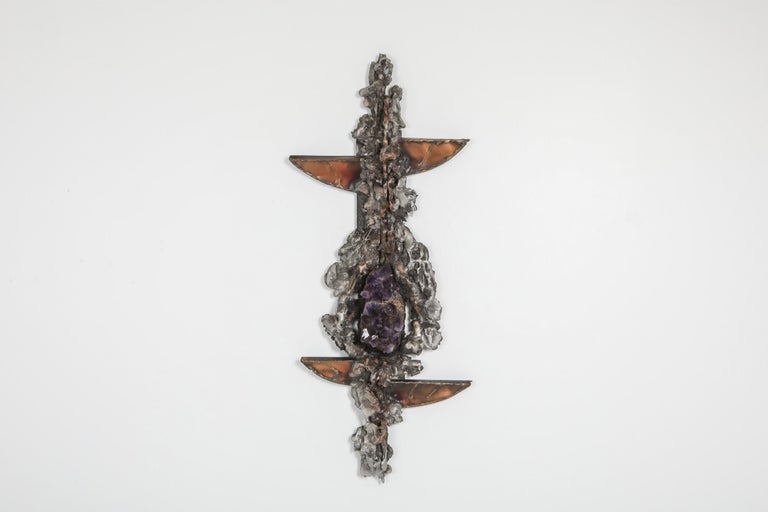 Art sculpture by Marc D’haenens, the 1970s.

The piece shows a variety of organic shapes in metal and copper, and a large piece of Amethyst as centerpiece.
 