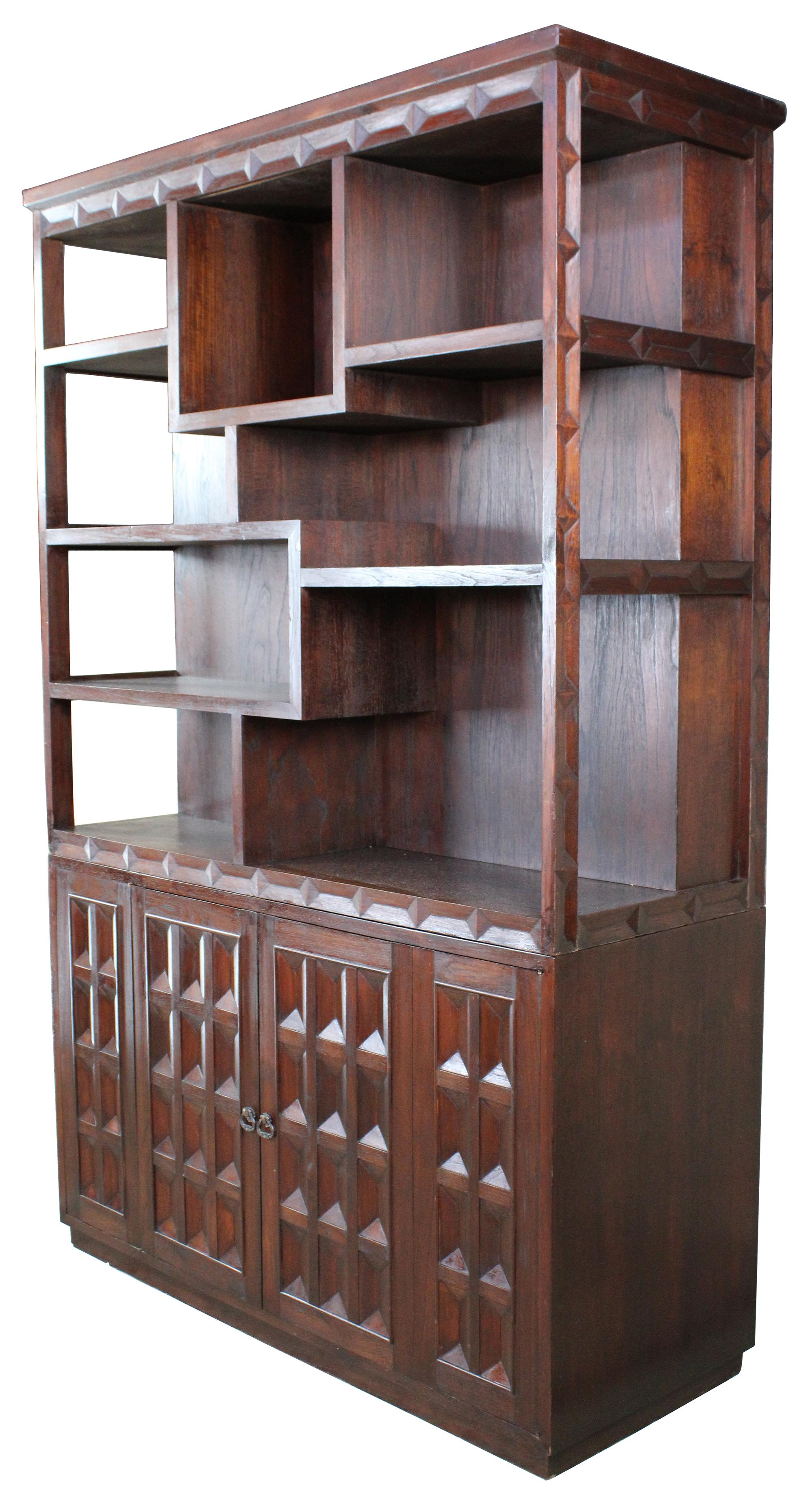 Brutalist room divider, circa 1960s. A double sided design with sculptural and traditional shelving. Great for display of books or collectibles. The base features additional storage and drawers.
 