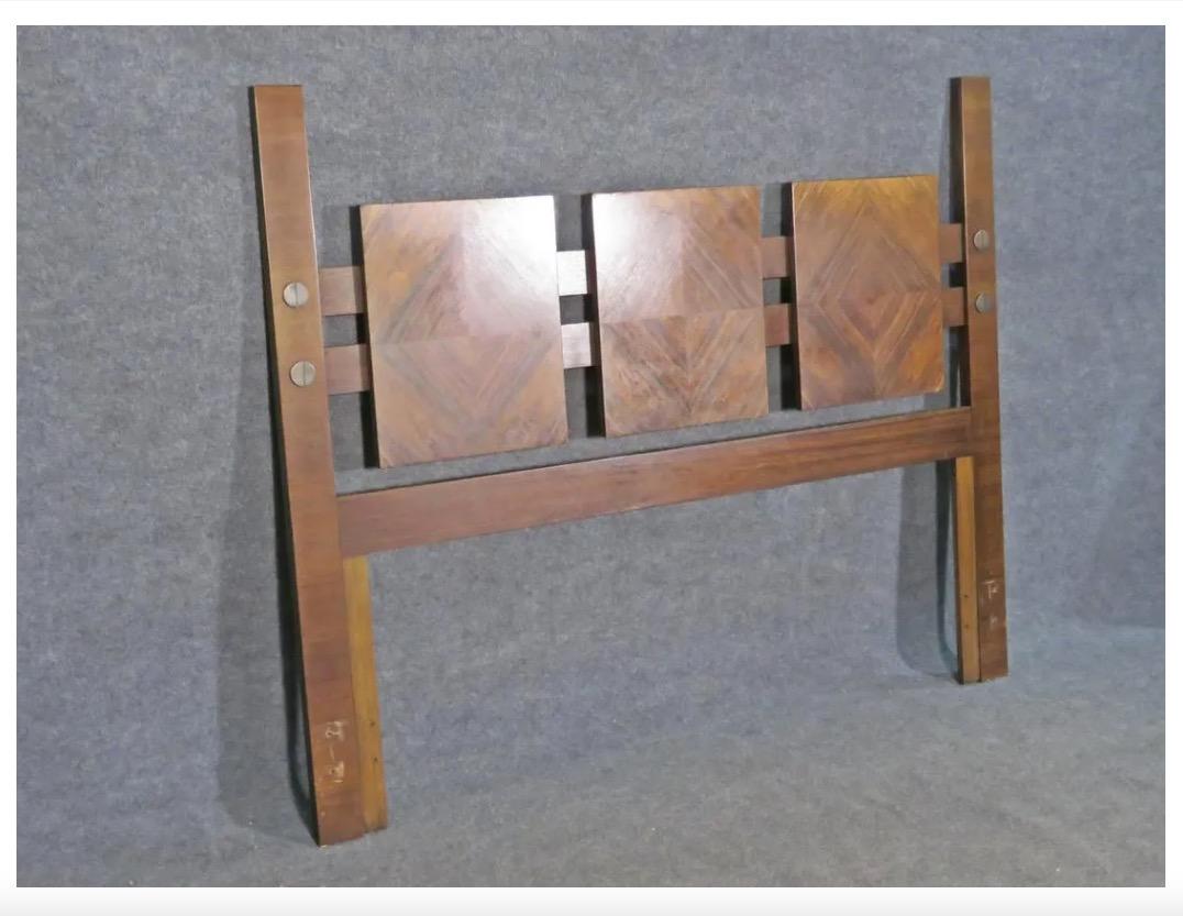 With a unique diamond-shaped pattern of woodgrain on three of the headboard's panels, this Brutalist walnut piece by Lane is a great Mid-Century addition to any bedroom. Please confirm item location with seller (NY/NJ).