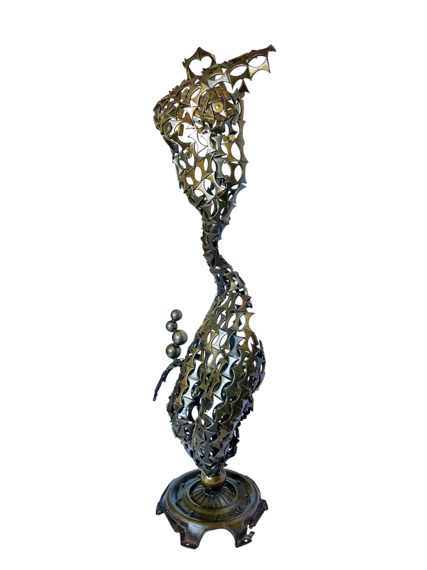This alluring brutalist abstract mermaid floor sculpture has been hand skillfully crafted out of hundreds of individually welded steel pieces of various shapes. Its intriguing 360 degree design features a torso form upper body, an elongated and