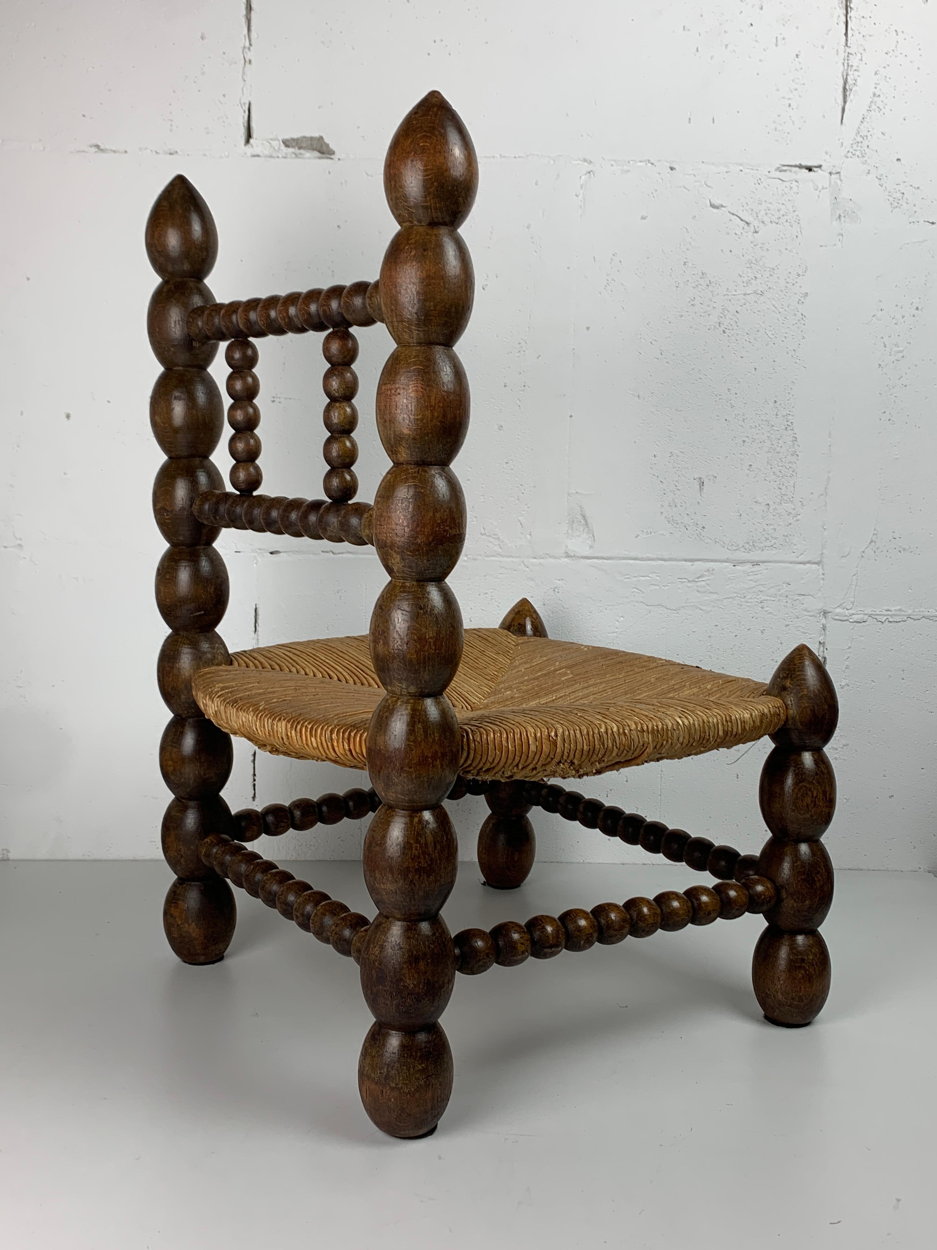 Brutalist wood turned bobbin low rush chair in the style of Charles Dudouyt 3